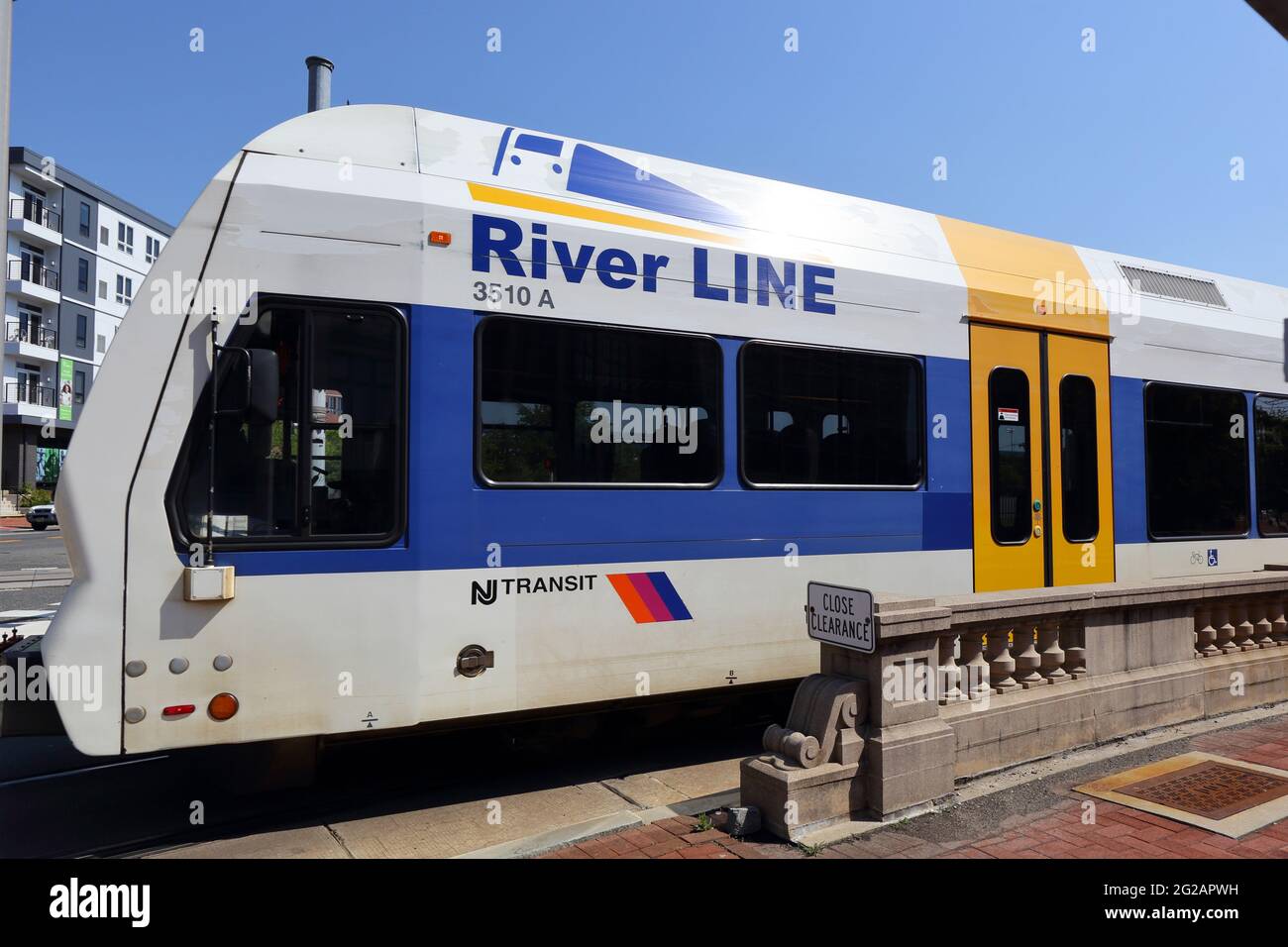 A NJ Transit River Line diesel light rail train makes a turn in the Cooper Grant, Camden waterfront in New Jersey. Stock Photo