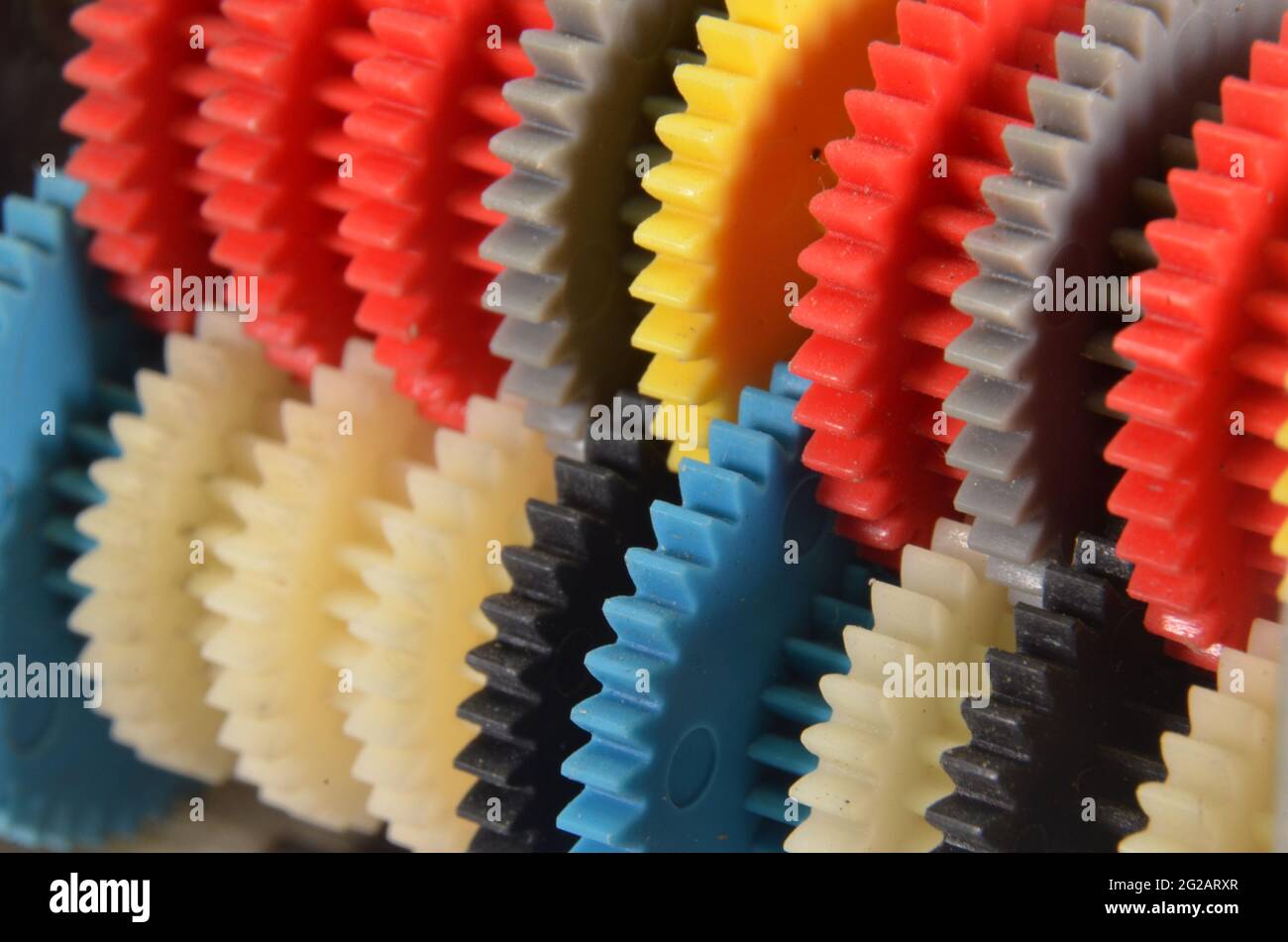 Diagonal view of a row with colorfulgear wheels Stock Photo