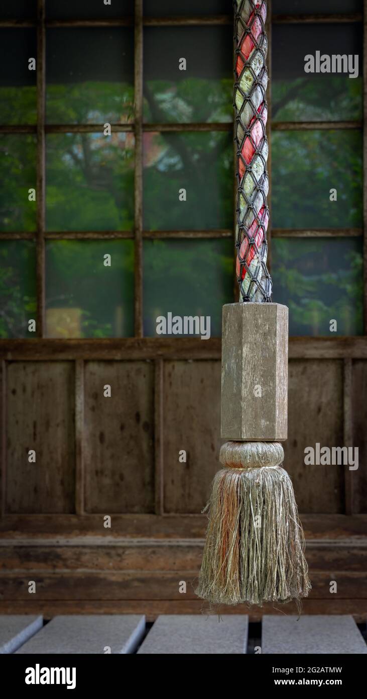 A decorative rope hangs from a building near the Myohoji Temple in Kamakura, Japan. Stock Photo