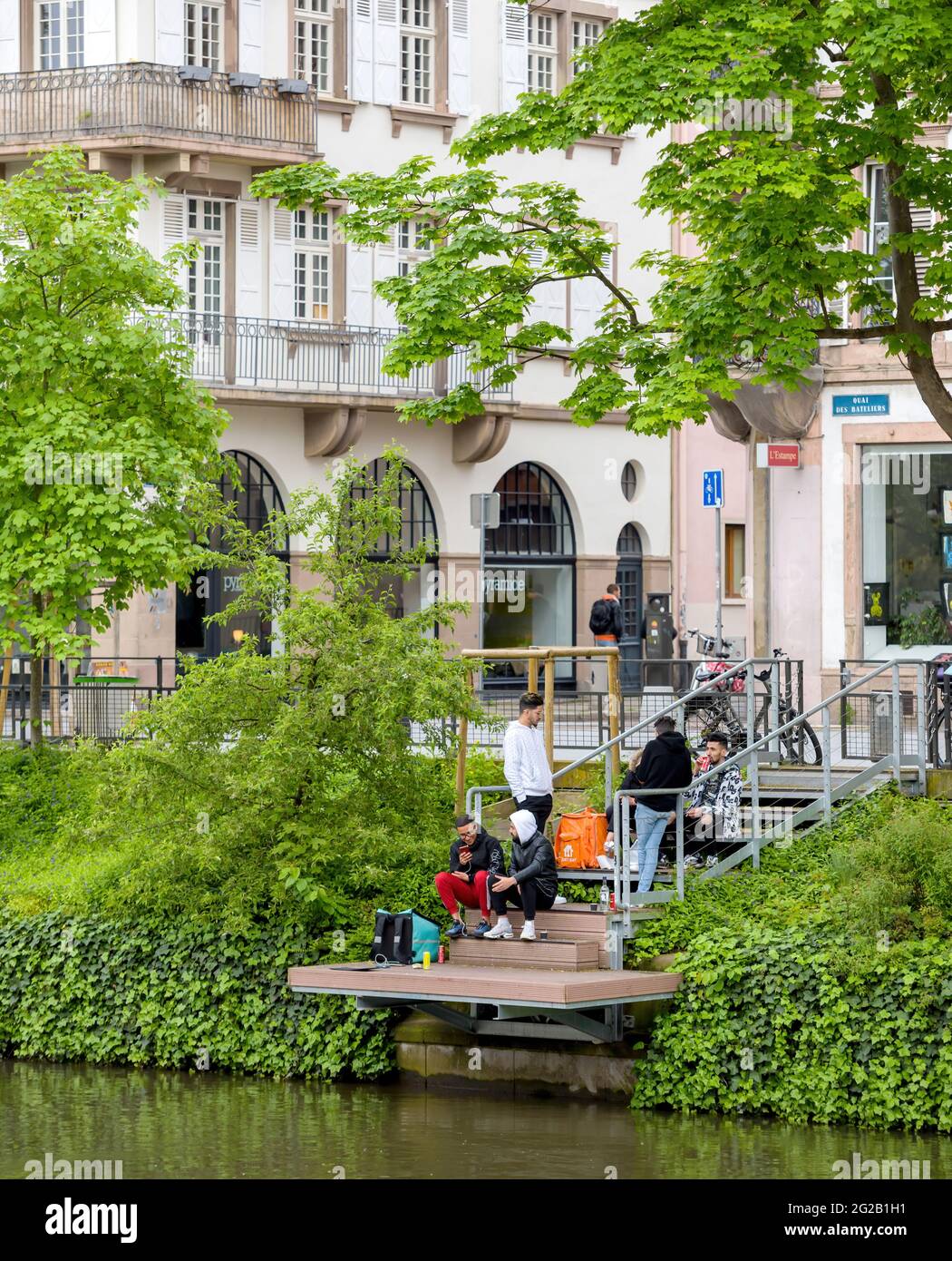 Deliveroo and just Eat drivers drinking resting eating near the river Stock Photo