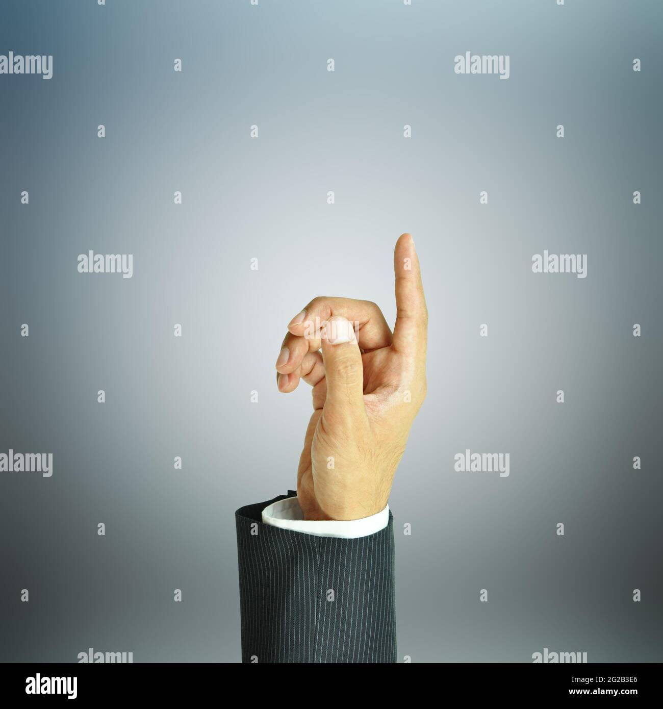 Businessman hand pointing up on gray background Stock Photo
