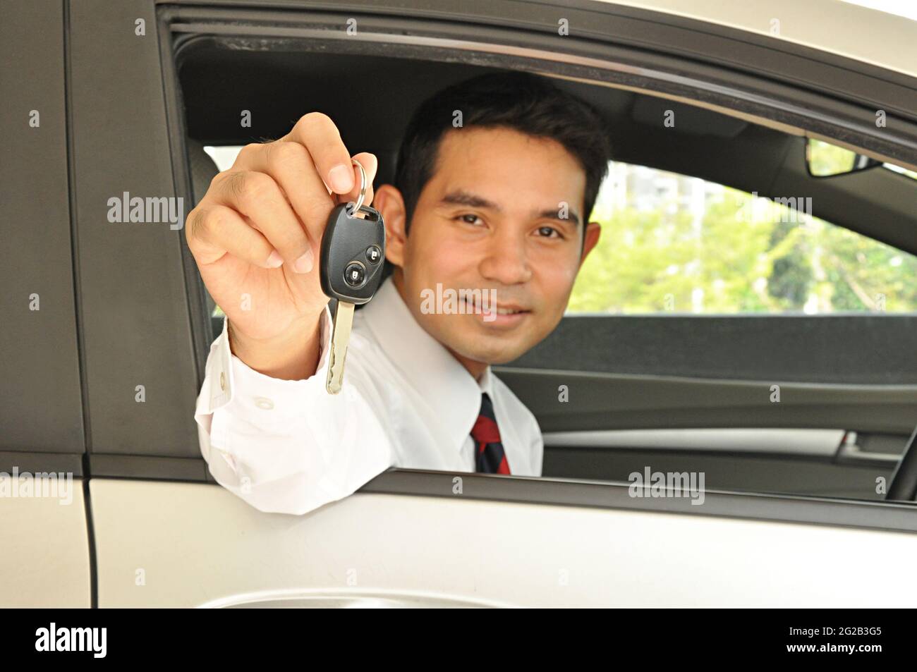 Businessman giving car key Stock Photo