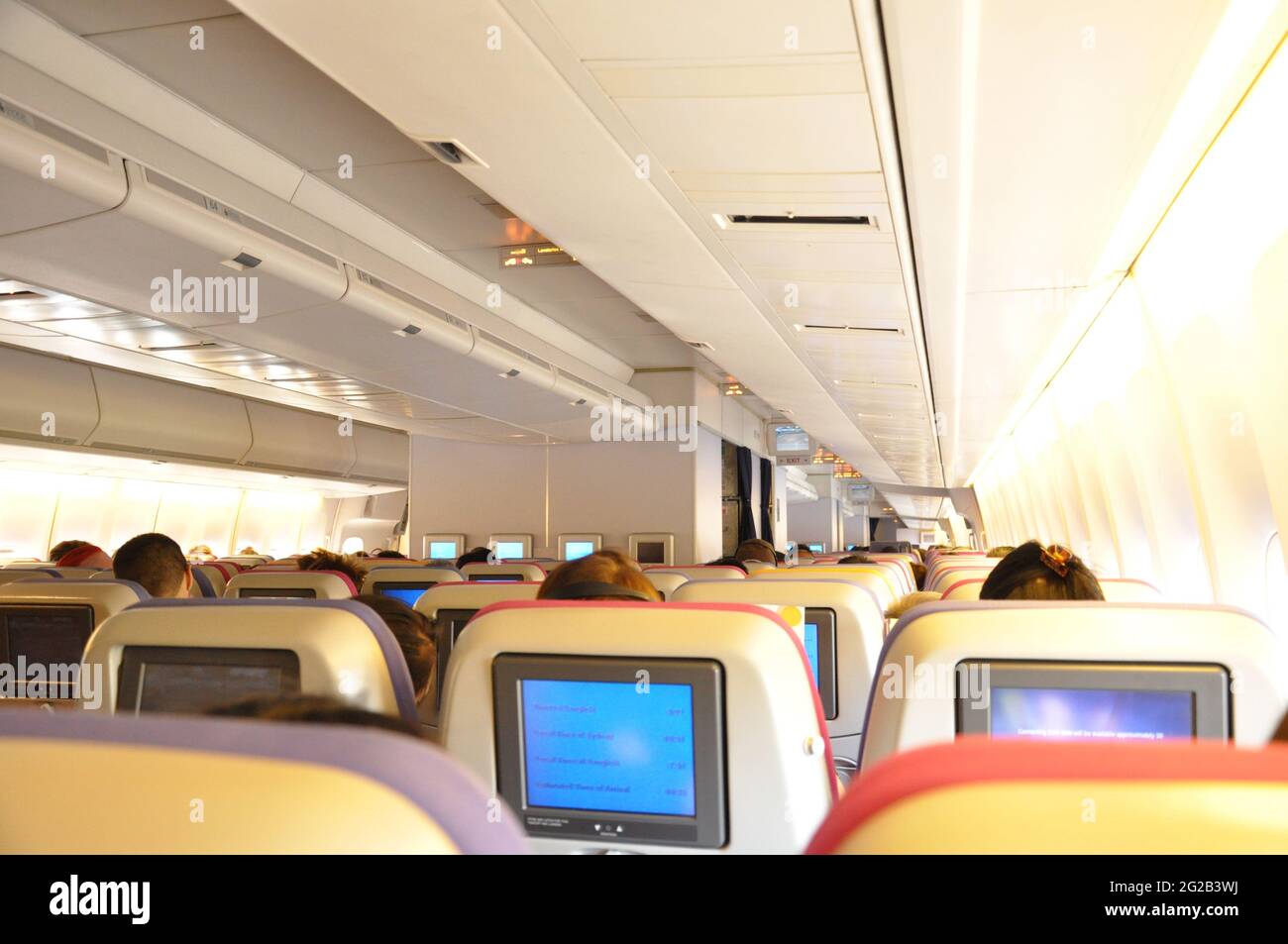 Aircraft cabin with passengers Stock Photo