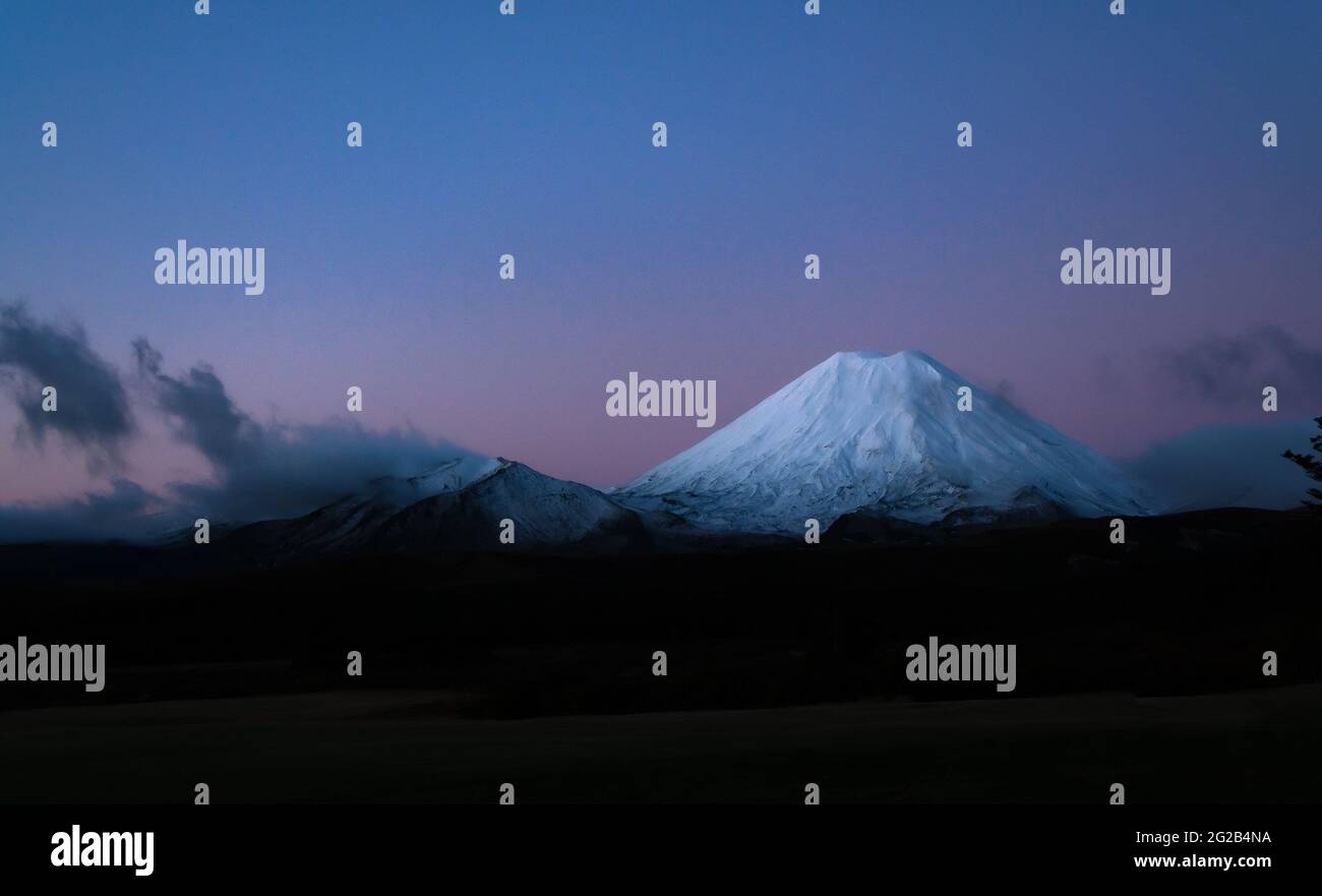 A suggestive view of the snow-capped Mount Tongariro at dusk Stock Photo