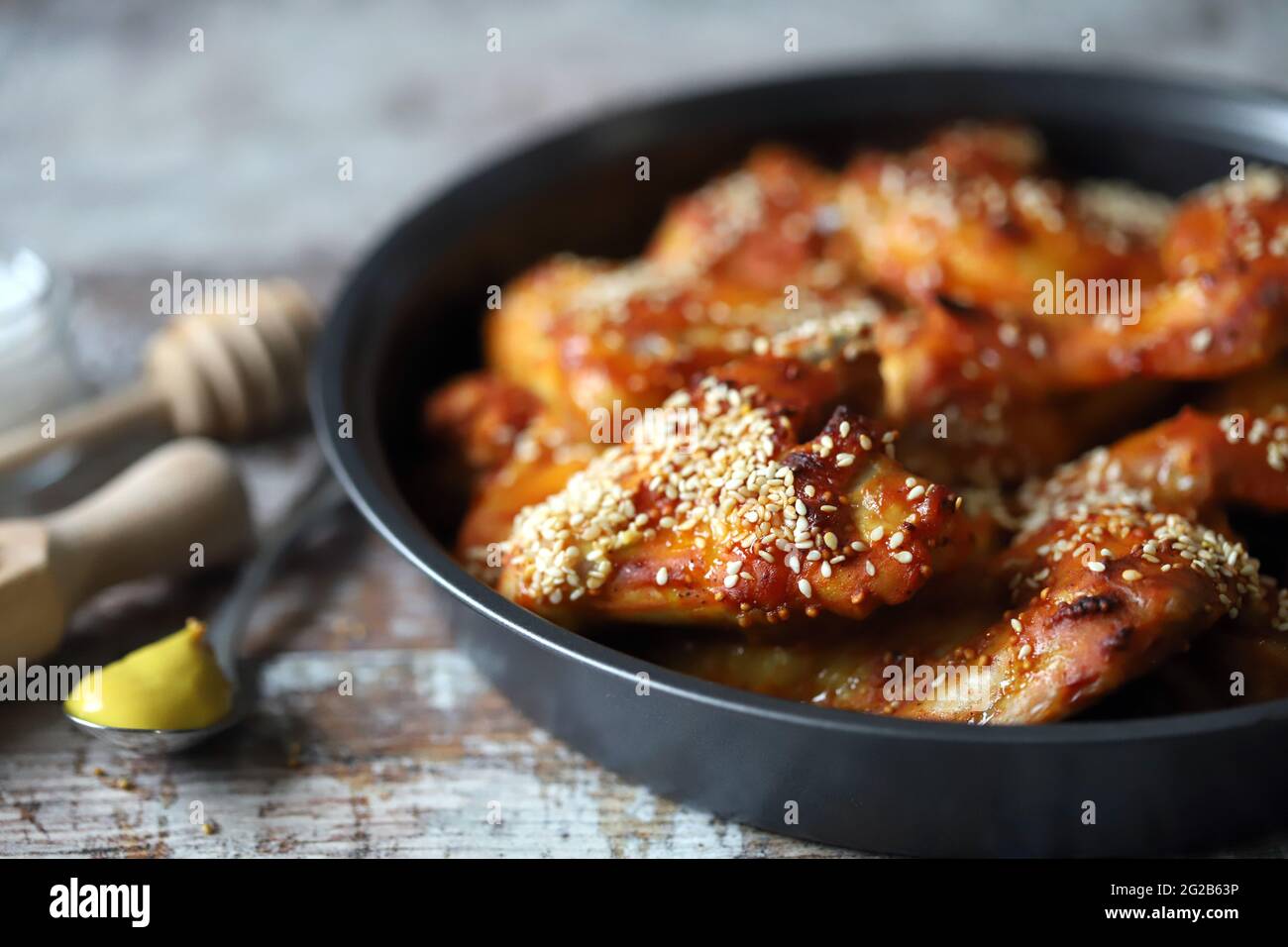 Baked chicken wings with sesame seeds in a skillet. Junk food