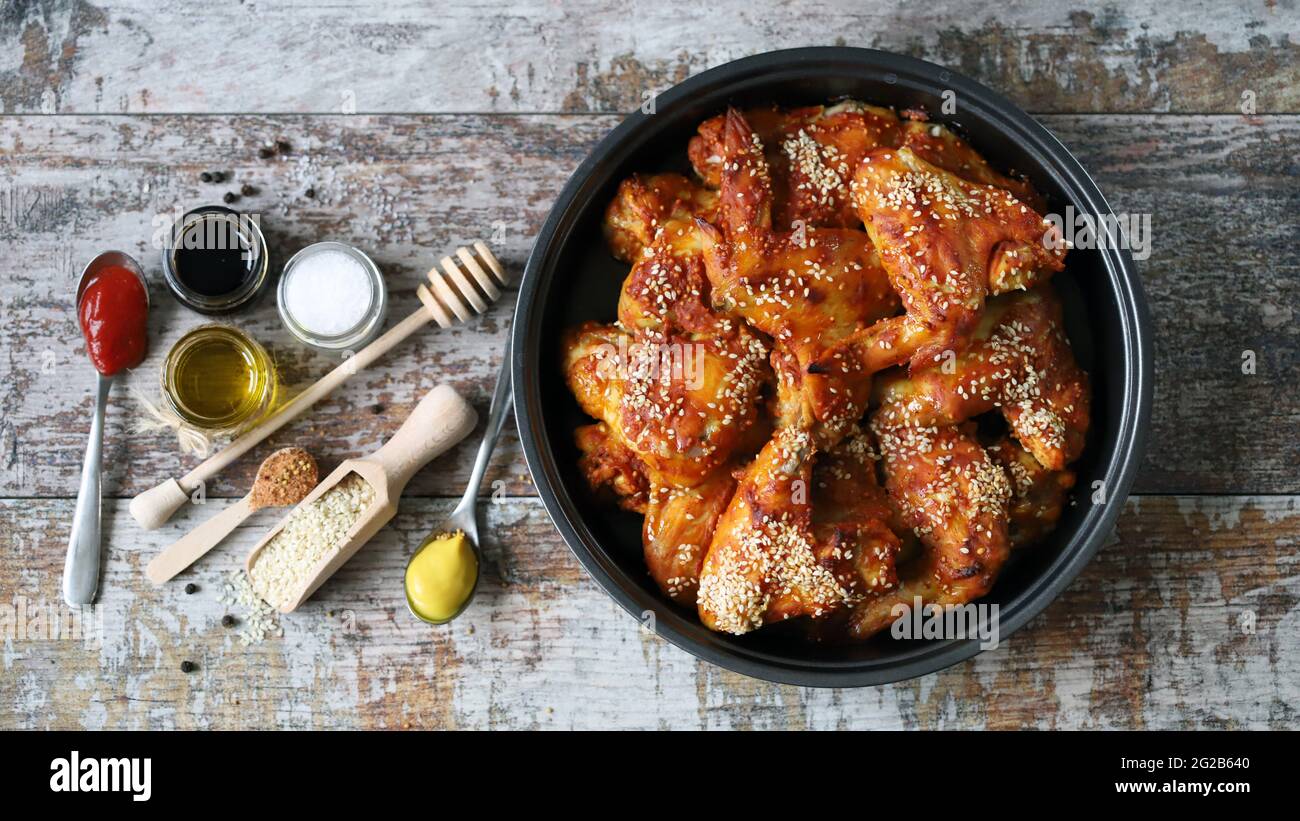 Baked chicken wings with sesame seeds in a skillet. Junk food