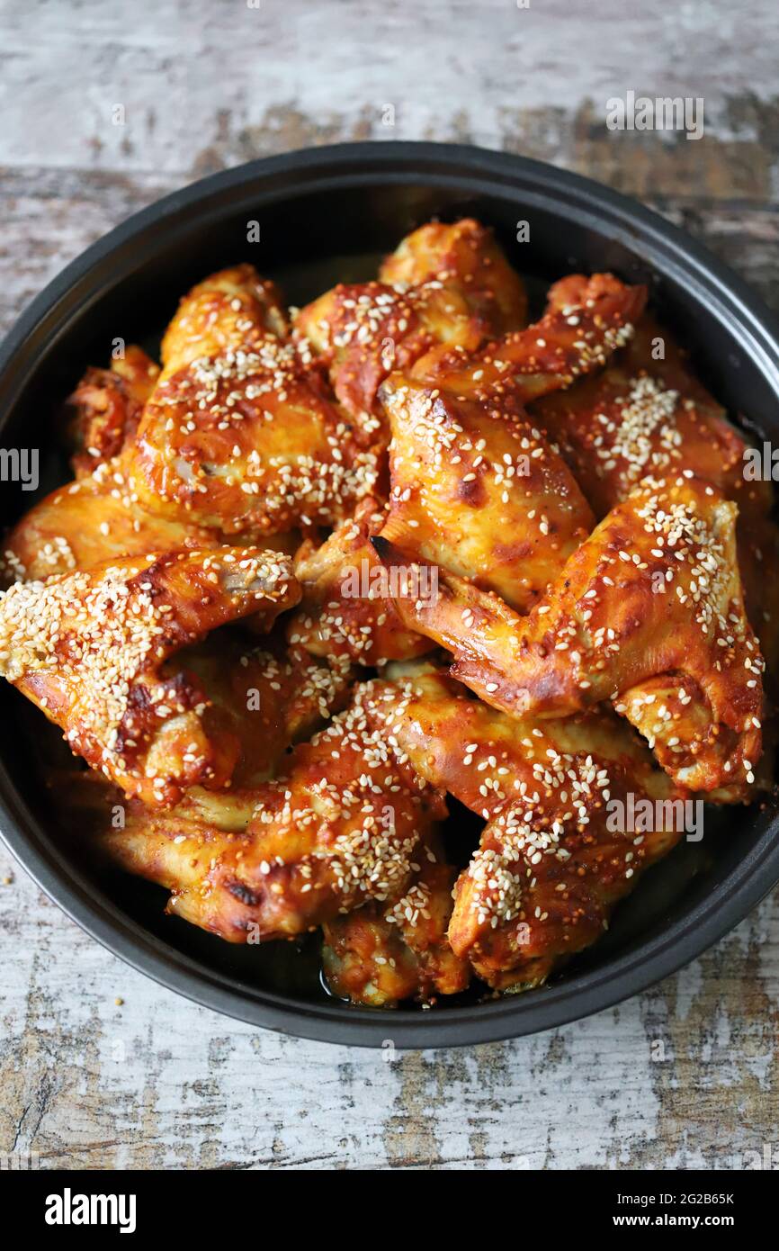 Appetizing buffalo wings in a pan. Baked chicken wings with sesame ...