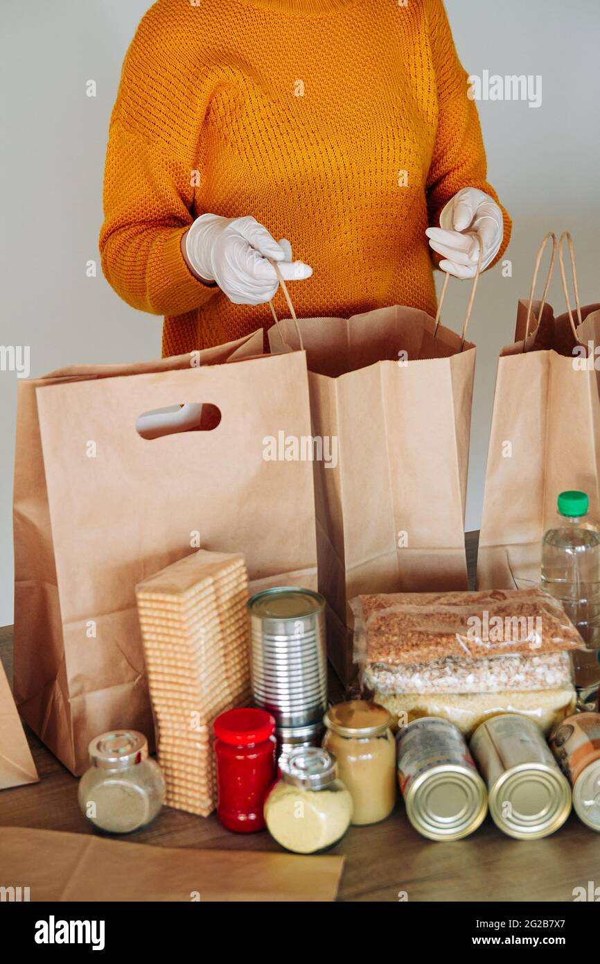 Hands in gloves packing hi-res stock photography and images - Alamy