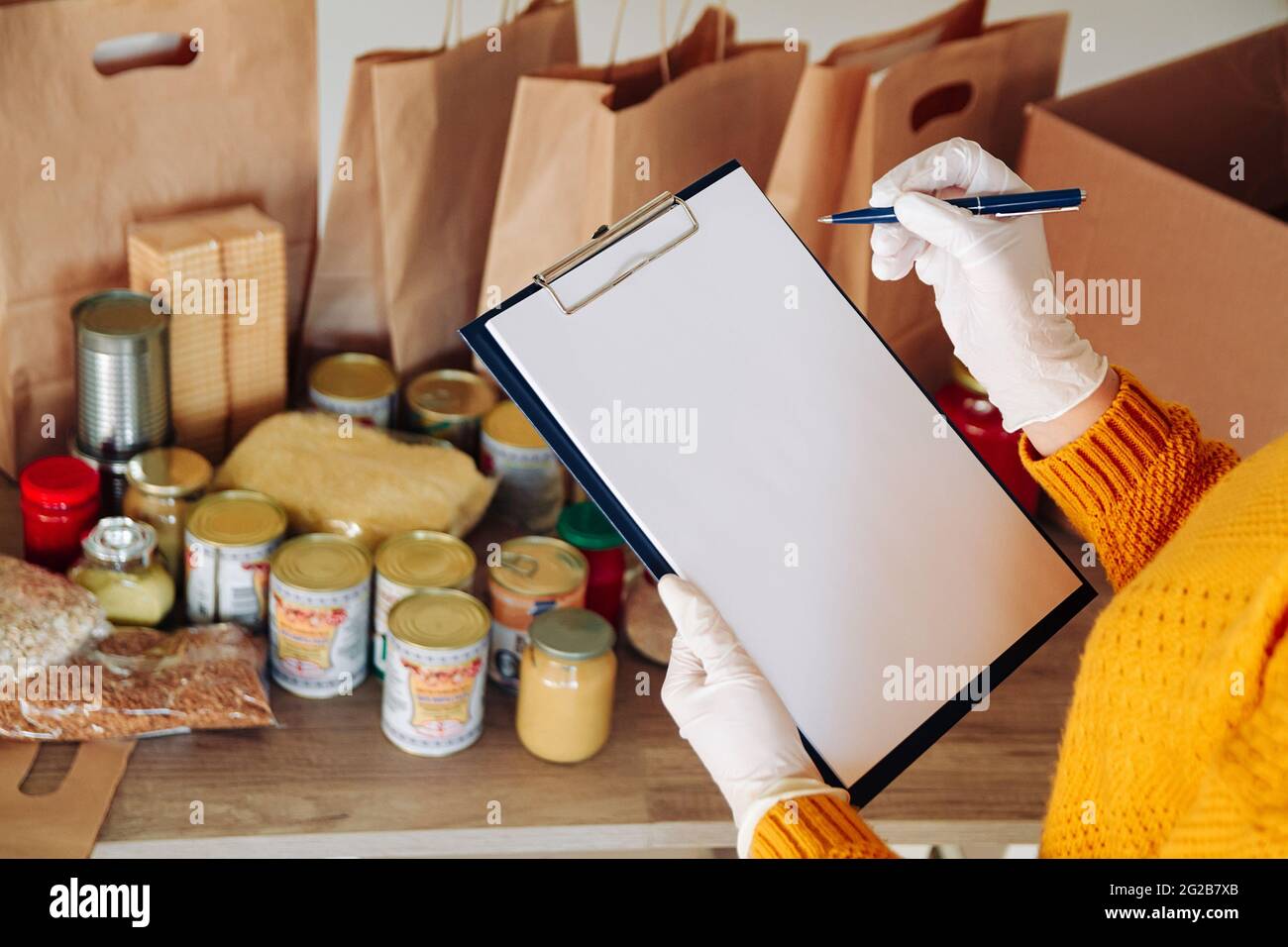Hands in gloves packing hi-res stock photography and images - Alamy