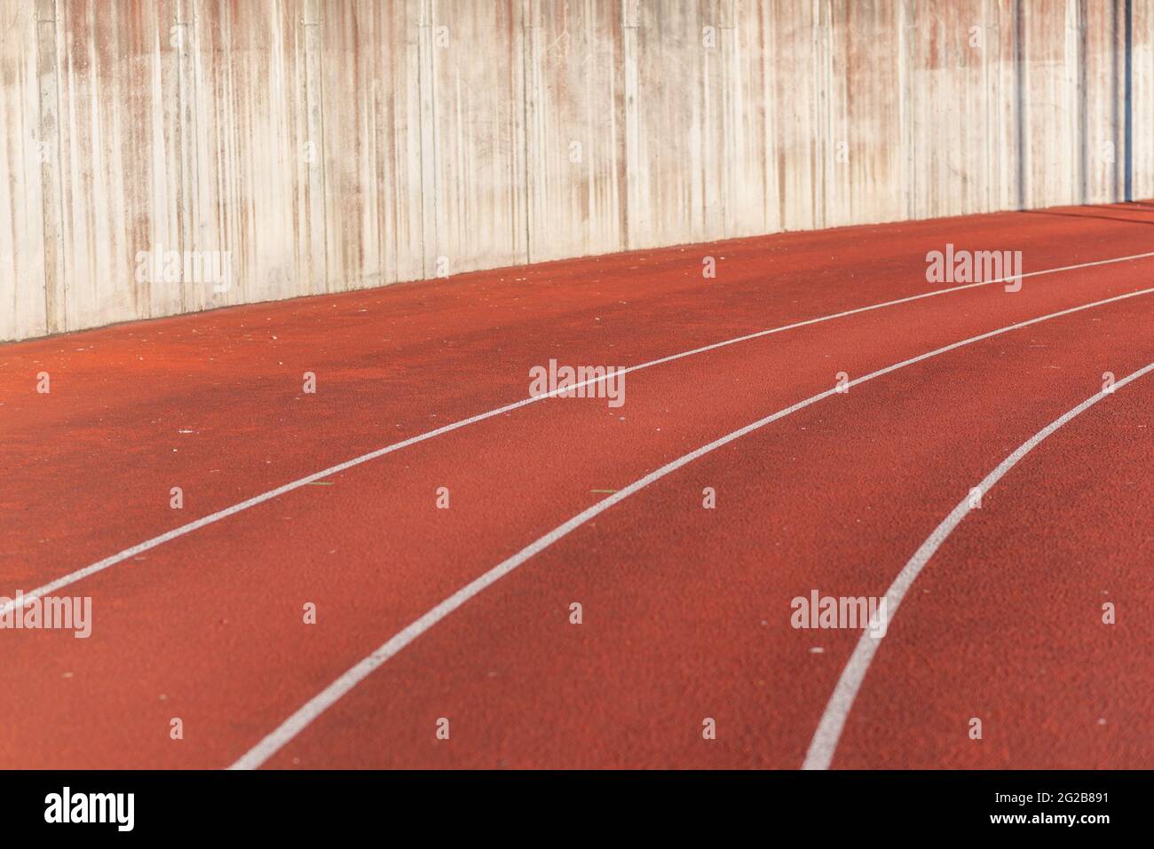 Part Red plastic track in the outdoor track and field stadium.Closeup. Stock Photo