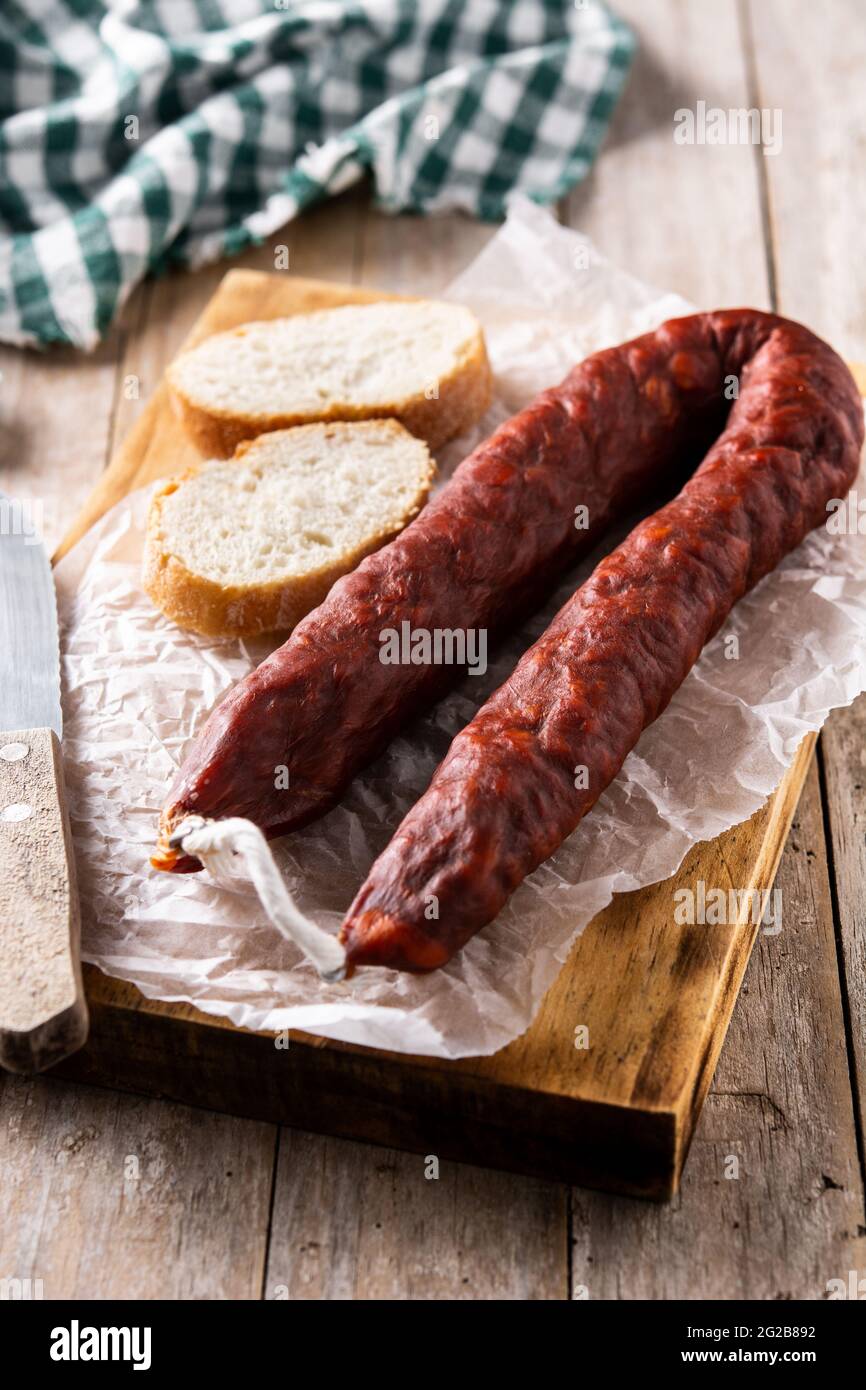 Spanish chorizo sausage on rustic wooden table Stock Photo - Alamy