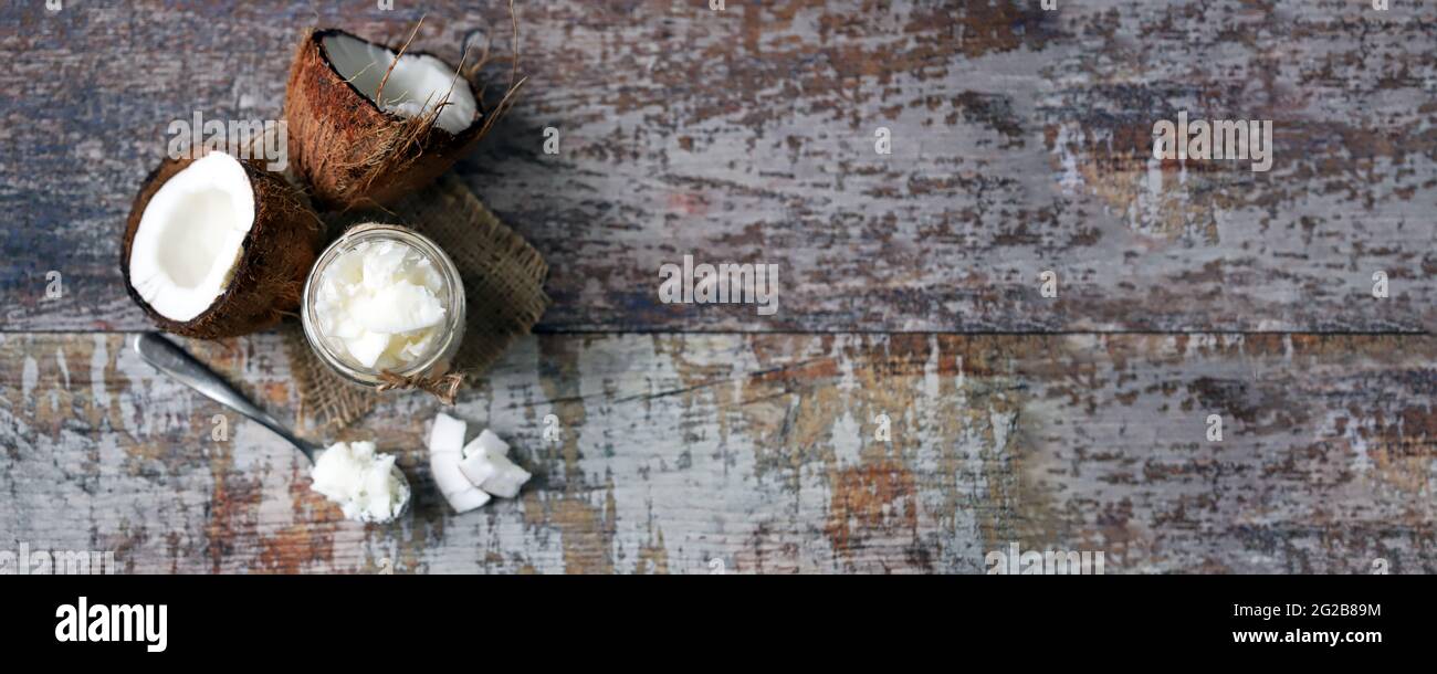 Coconut oil in a jar. Coconut halves Stock Photo Alamy