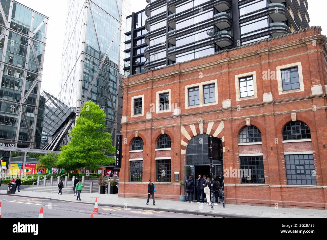 People at the entrance of The Light Bar at the old 1893 Victorian Norton Folgate Power Station in Bishopsgate East London EC2 England UK  KATHY DEWITT Stock Photo