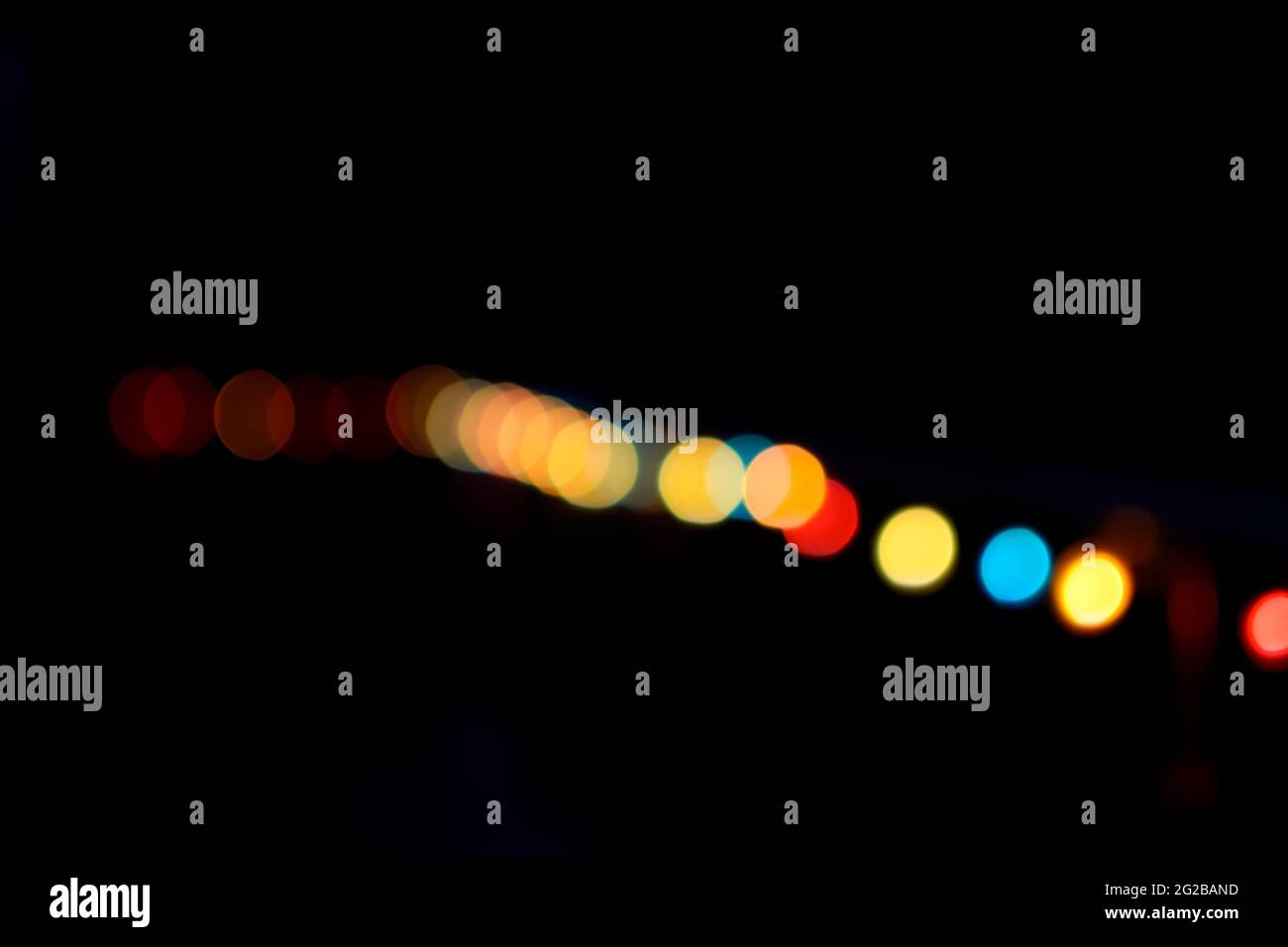 Deliberately defocused blurry abstract bokeh light background with various colors during night. Stock Photo