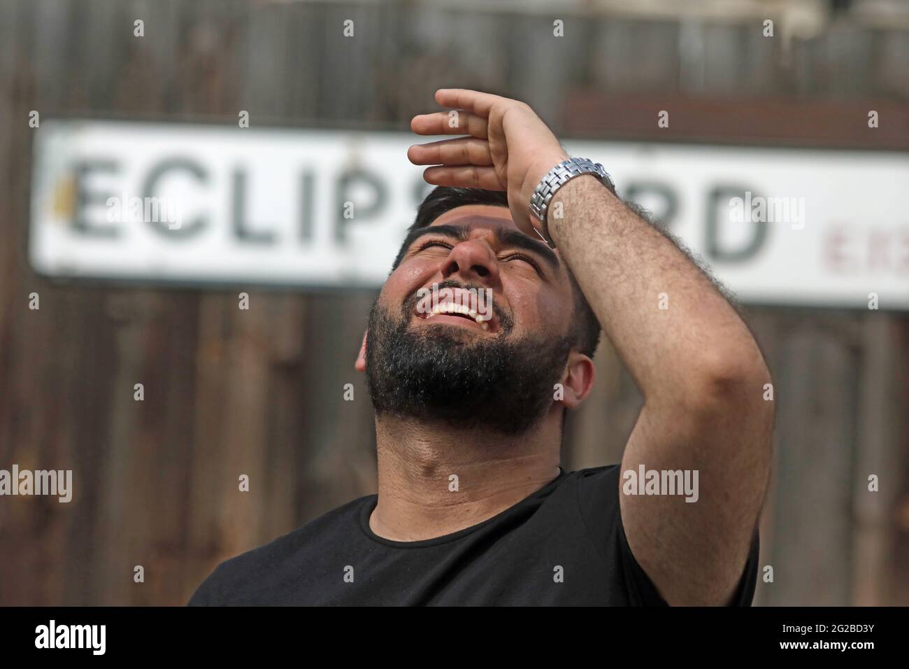 Hamza Qureshi looks towards the skies from Eclipse Road, in east London, during a partial solar eclipse. Picture date: Thursday June 10, 2021. Stock Photo