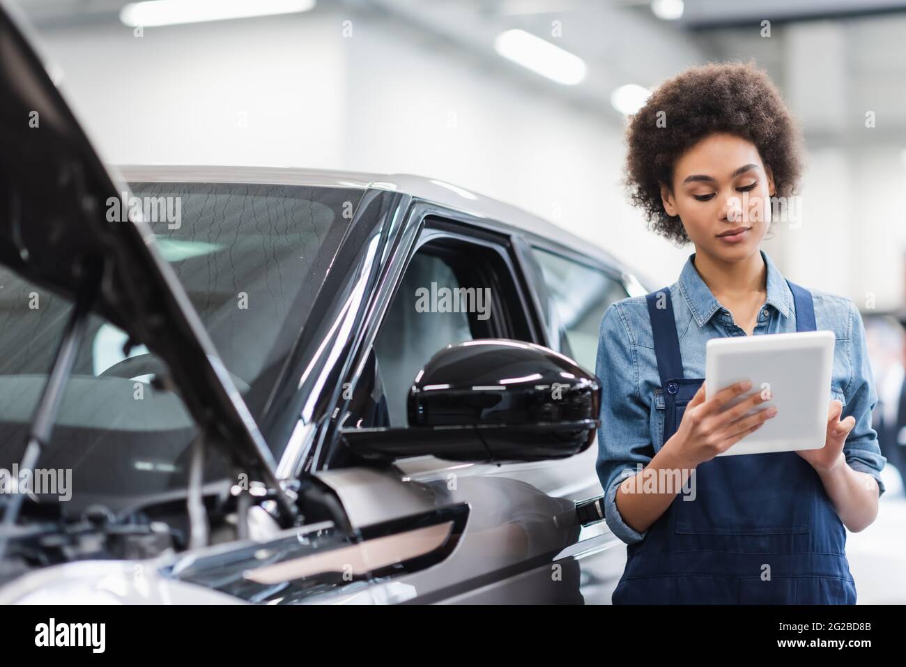 Mechanic using tablet inspecting hi-res stock photography and images ...