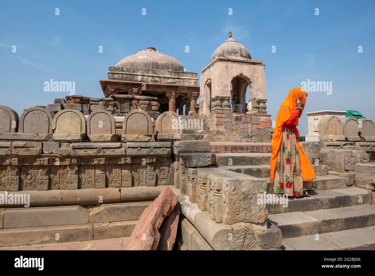 Rajasthani woman in traditional clothes steps down the ancient Harshat Mata Temple is a Hindu temple in the Abhaneri  village of Rajasthan.India Stock Photo