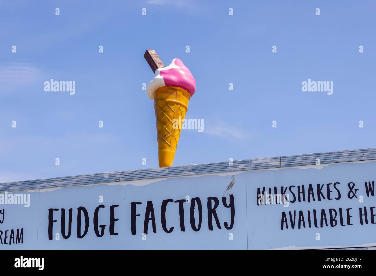 Ice-cream cone roof display on the front of gift shops and snack bars in Clarence Easpanade, Southsea, Portsmouth, Hampshire, south coast England Stock Photo