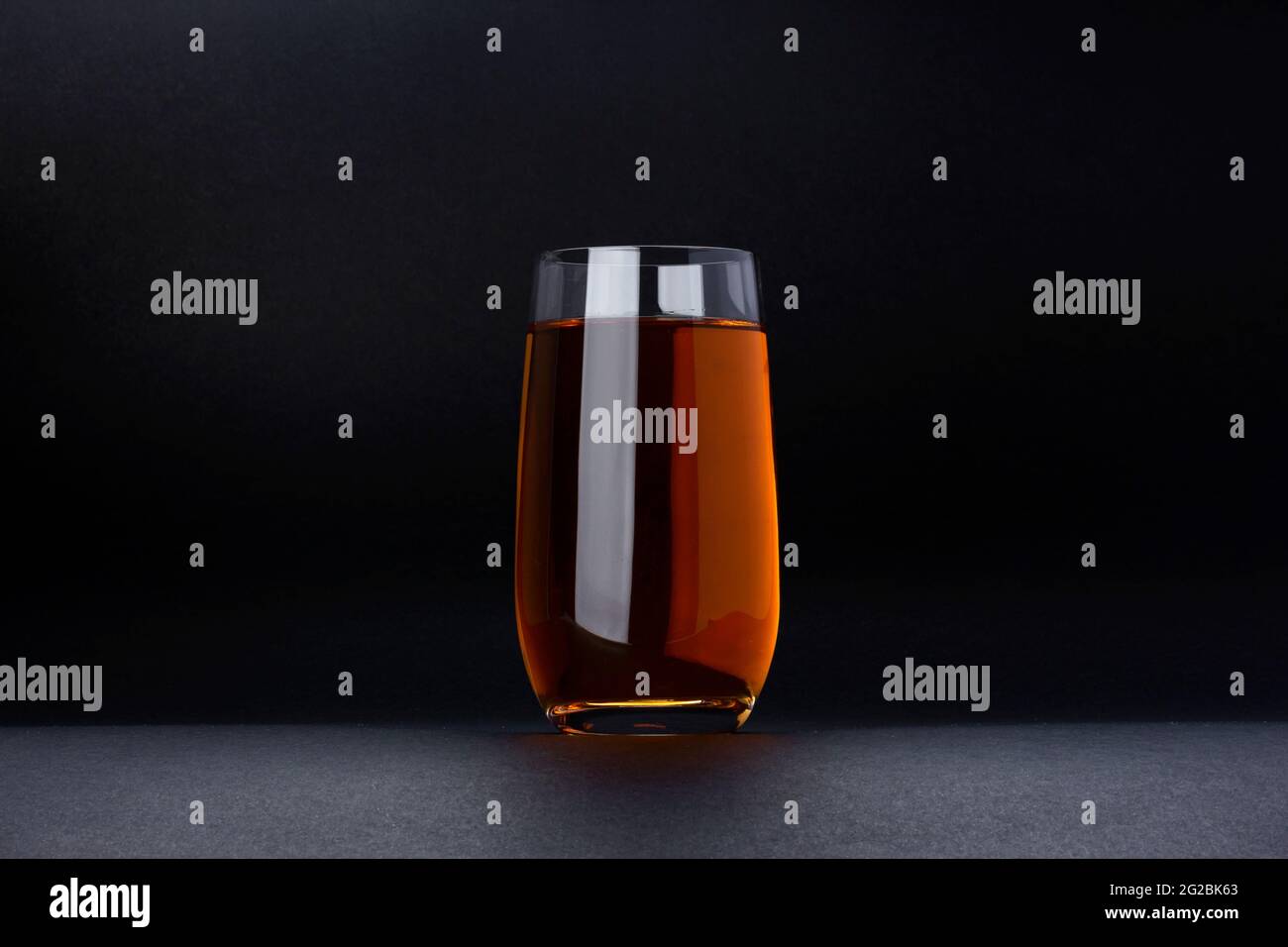 Glass of apple and grape juice on black background with copy space Stock Photo