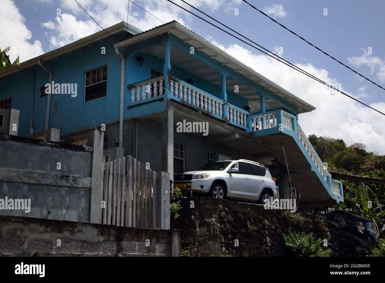 Grenada Car Parked Outside Blue house Near Gouyave Stock Photo