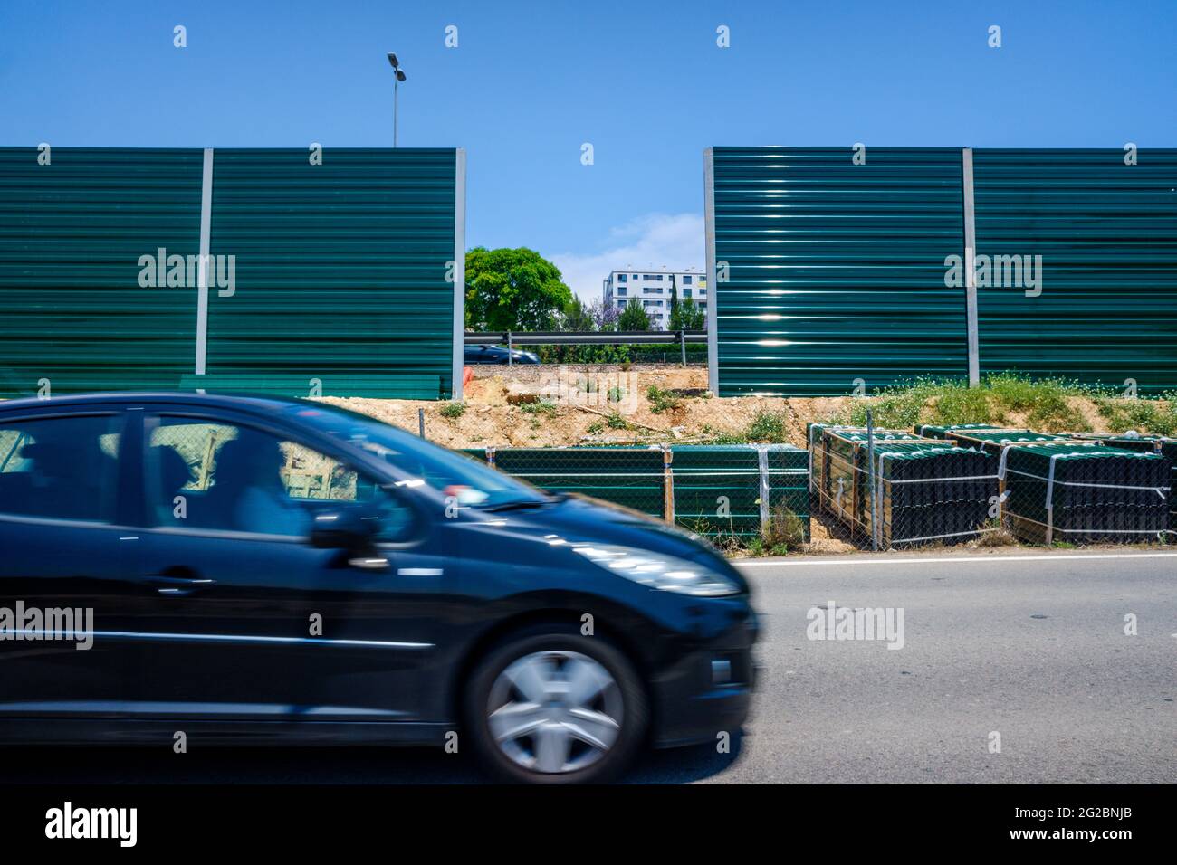 Valencia, Spain - June 9, 2021: Construction material next to a noisy road to isolate nearby homes from noise. Stock Photo