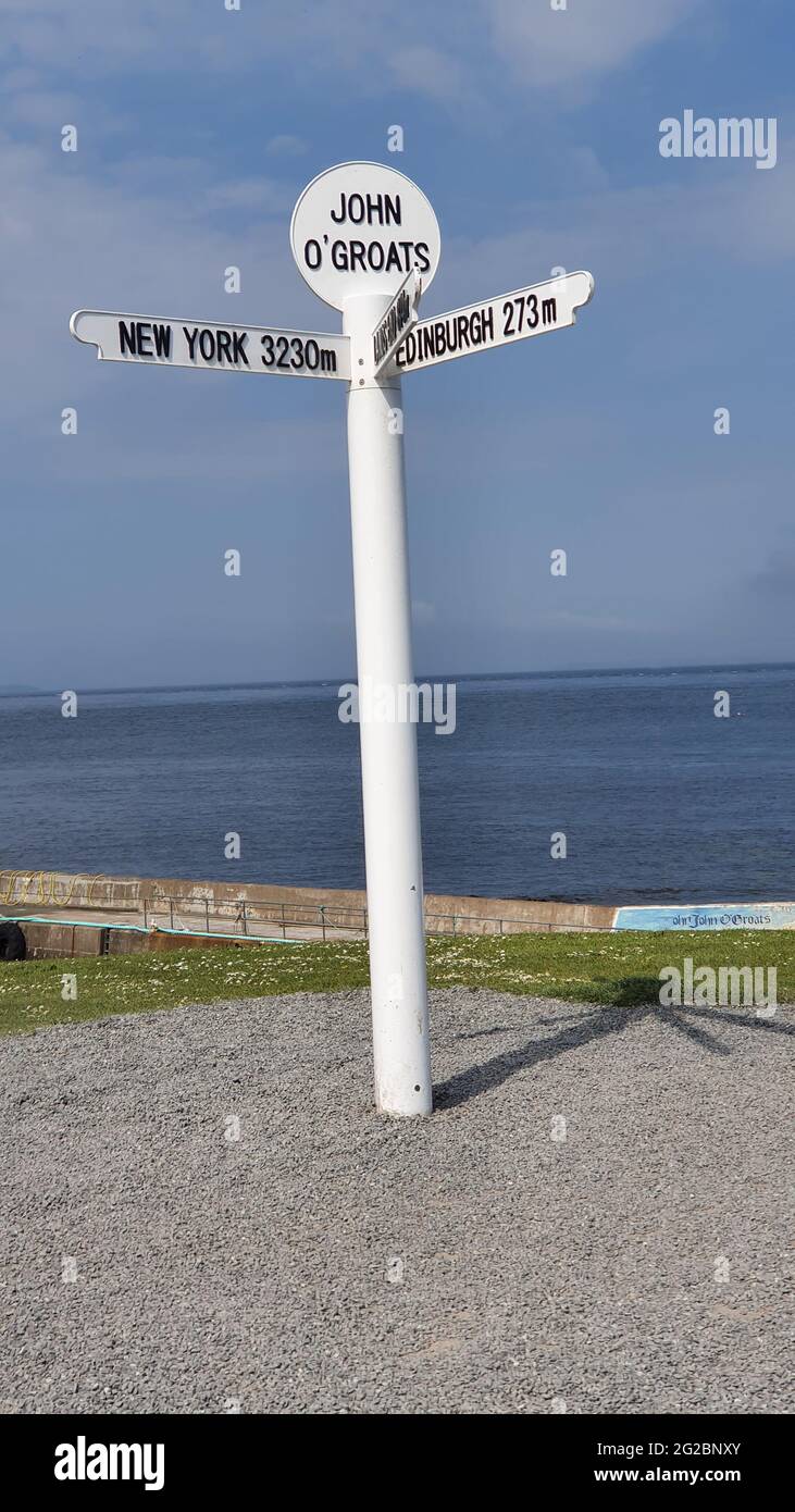 Famous signpost at John O'Groats, the most northerly point on the mainland of, showing distances to New York, Edinburgh, Land's End, Orkney and Shetla Stock Photo
