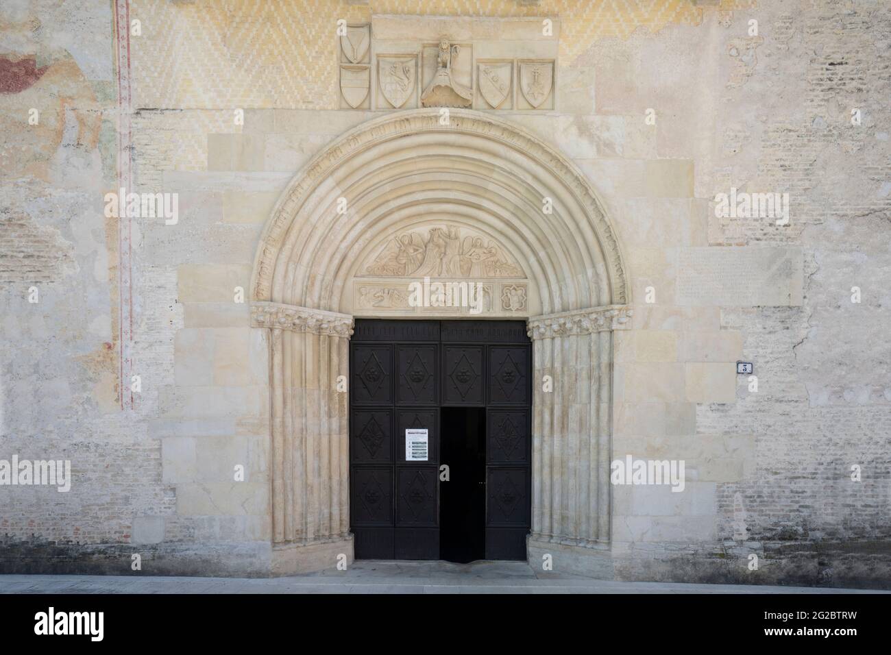 Spilimbergo, Italy. June 3 2021. Detail of the decoration on the entrance door of the cathedral of Santa Maria Maggiore in the center of the town Stock Photo