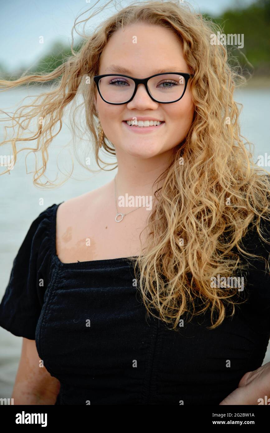 Beautiful Blonde hair girl wearing black shirt and jeans Stock Photo