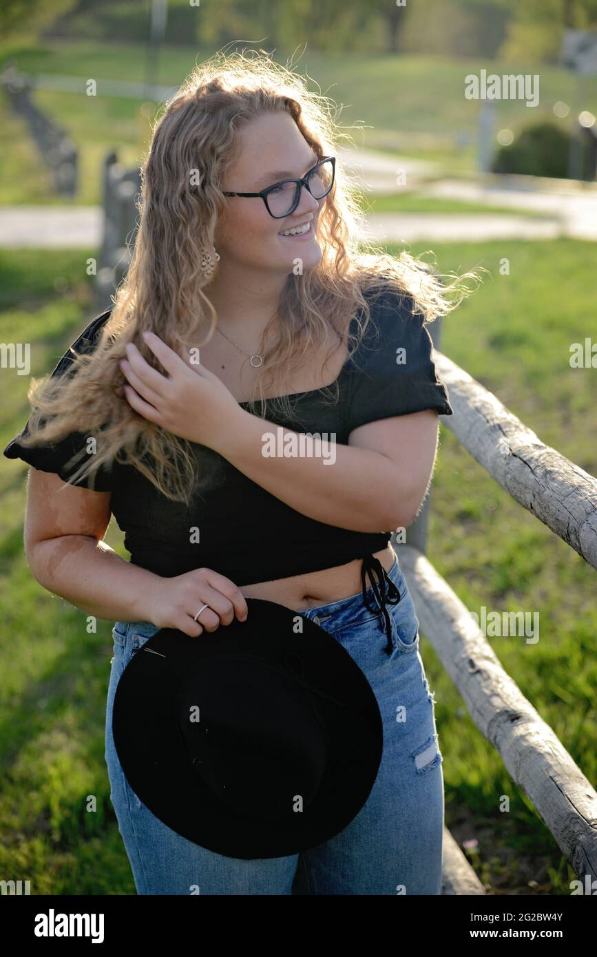 Beautiful Blonde hair girl wearing black shirt and jeans Stock Photo