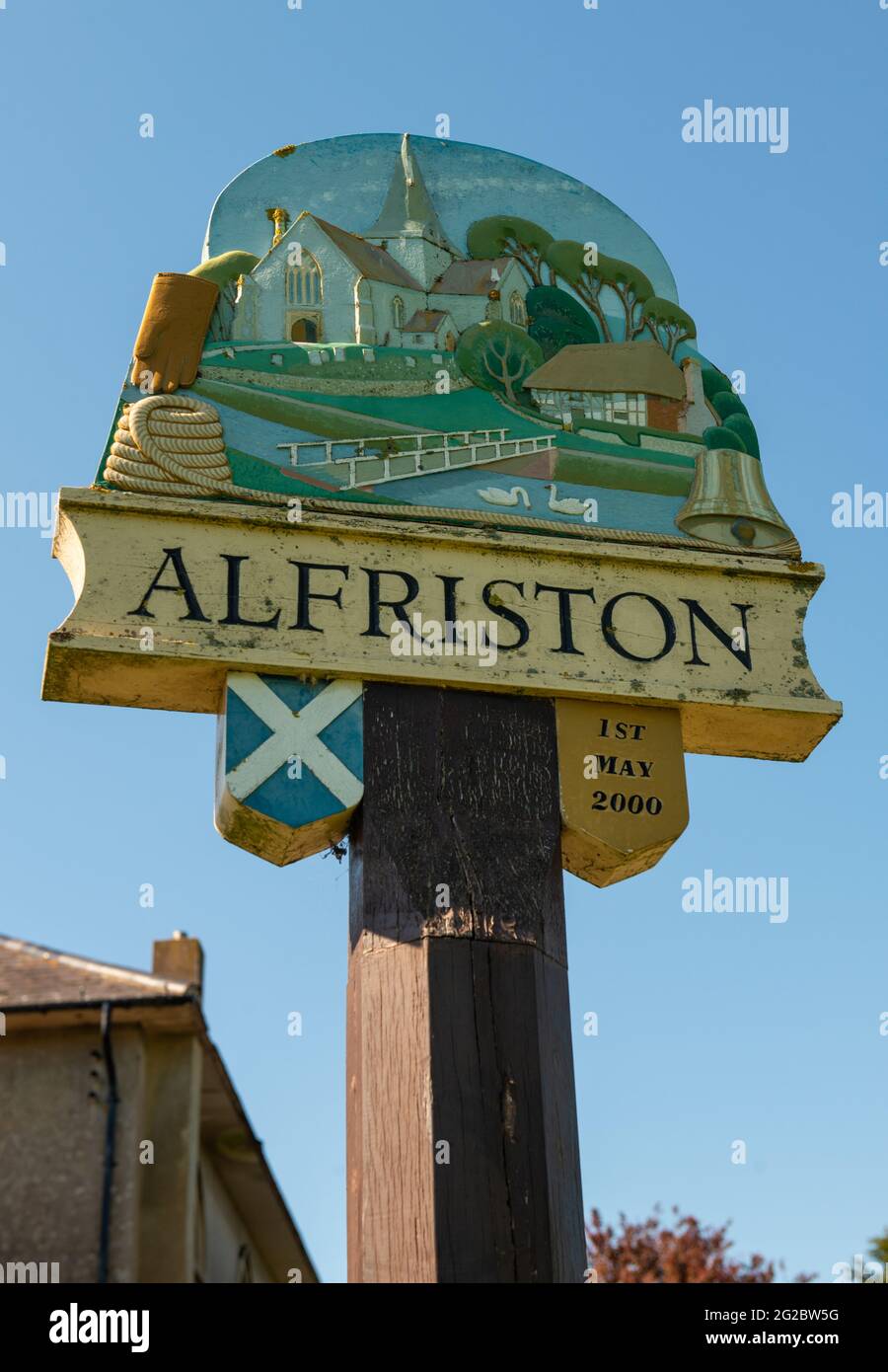 Alfriston, East Sussex, United Kingdom. 5th June 2021. Low angle view of Alfriston village sign, against a clear blue sky. Stock Photo