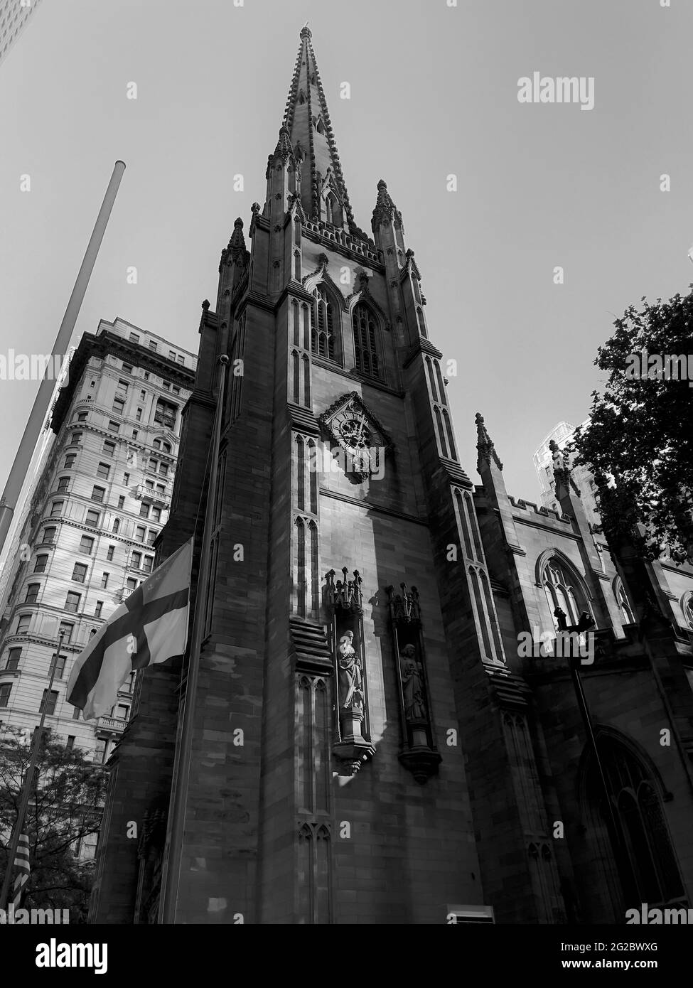 North side of the Trinity Church in Lower Manhattan’s financial district.  Strong vertical wide angle photograph. Stock Photo