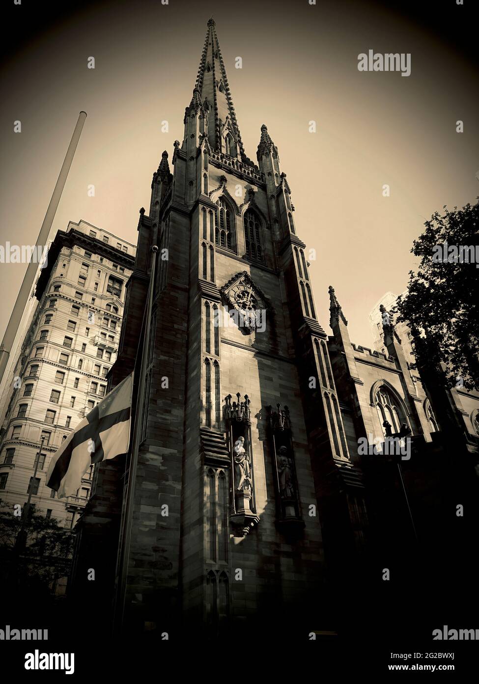 North side of the Trinity Church in Lower Manhattan’s financial district.  Strong vertical wide angle photograph. Stock Photo