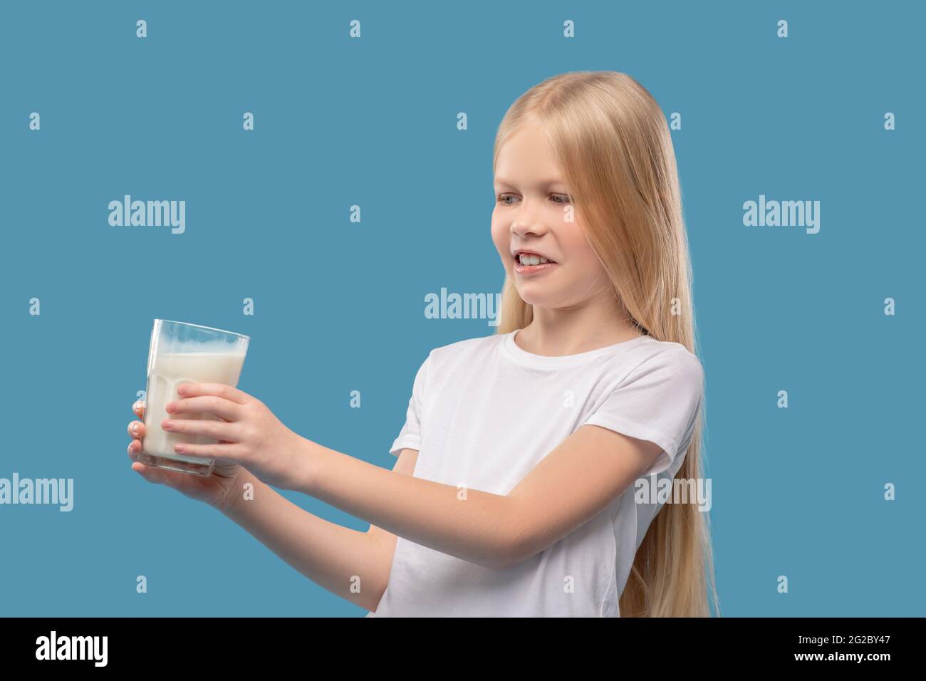 Displeased girl pushing away glass of milk Stock Photo