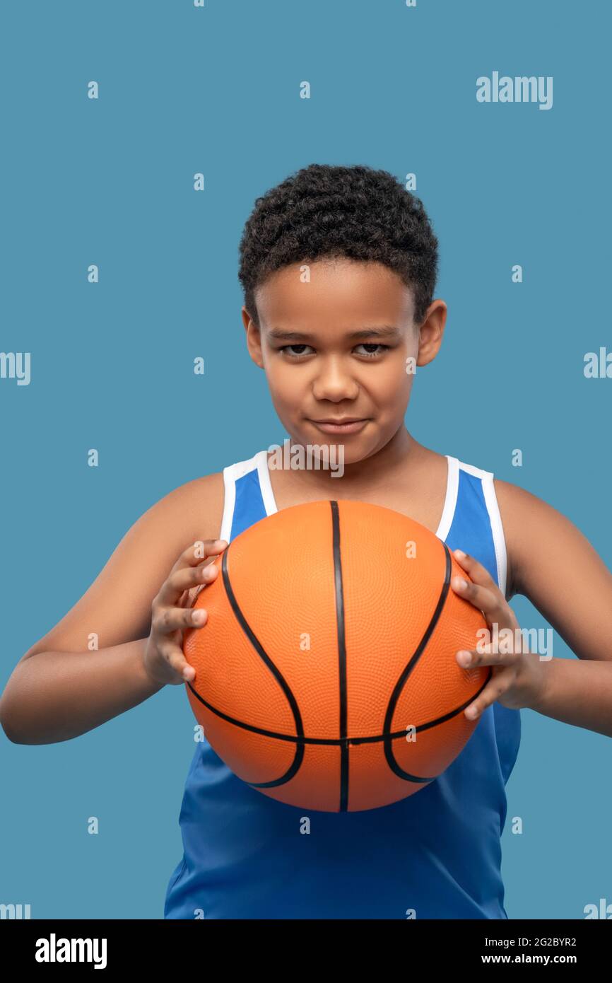 Attentive boy taking aim with ball in hands Stock Photo