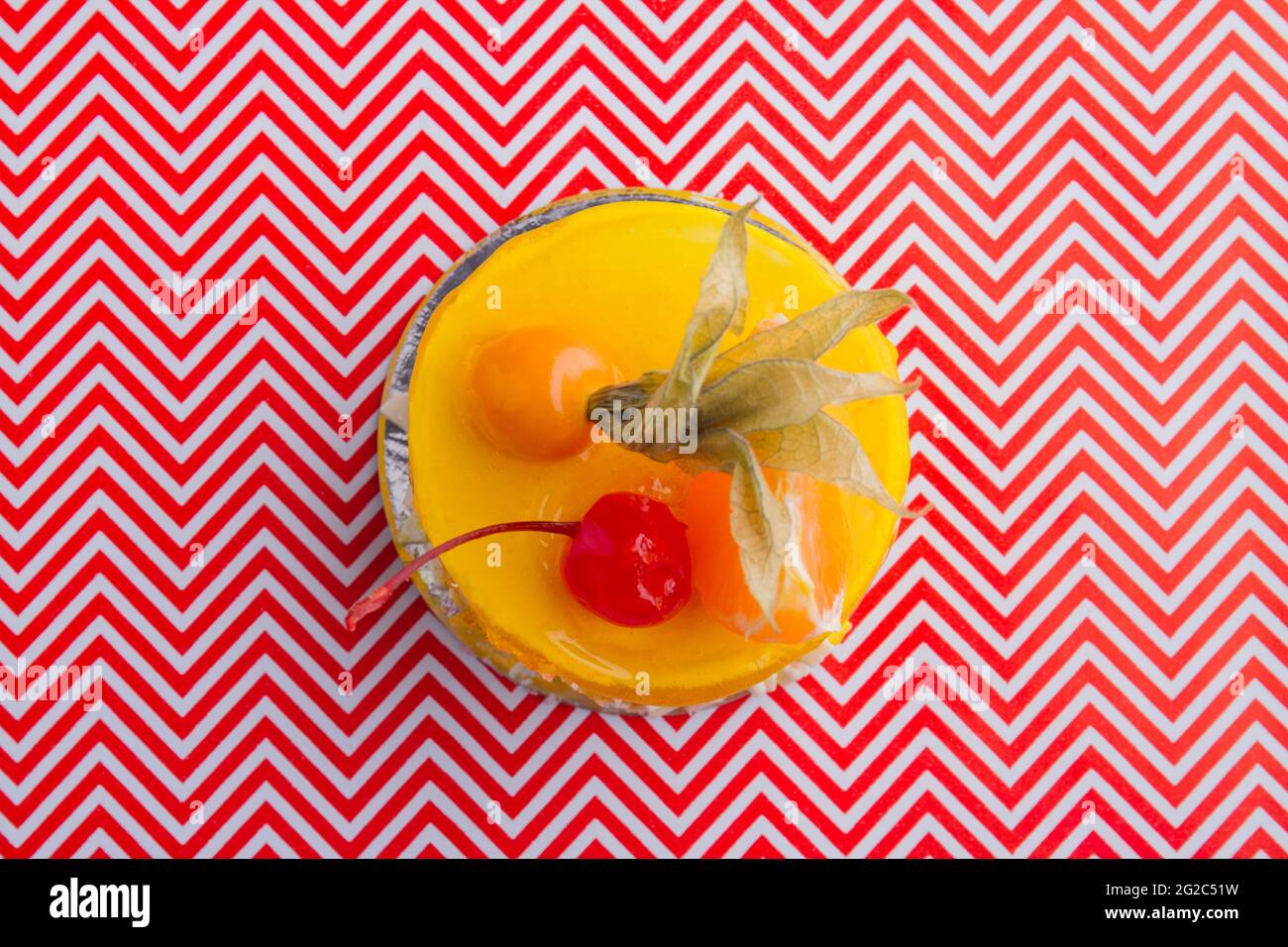 Top view of sweet yellow cake with fruits topping. Stock Photo