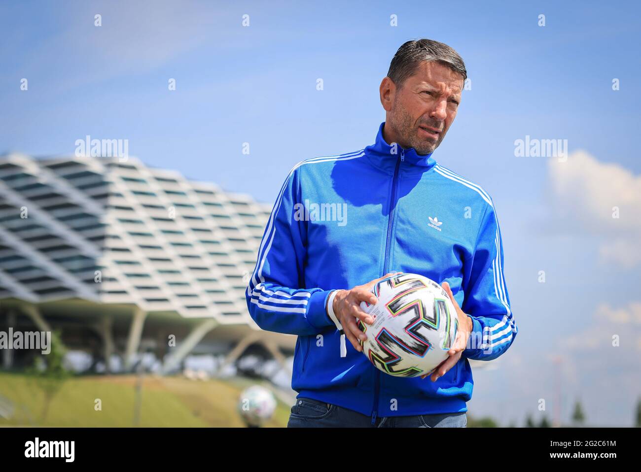Herzogenaurach, Germany. 10th June, 2021. Kasper Rorsted (2nd from right),  CEO of Adidas AG, holds an official EURO 2020 "Uniforia" match ball during  an interview in front of the DFB media centre