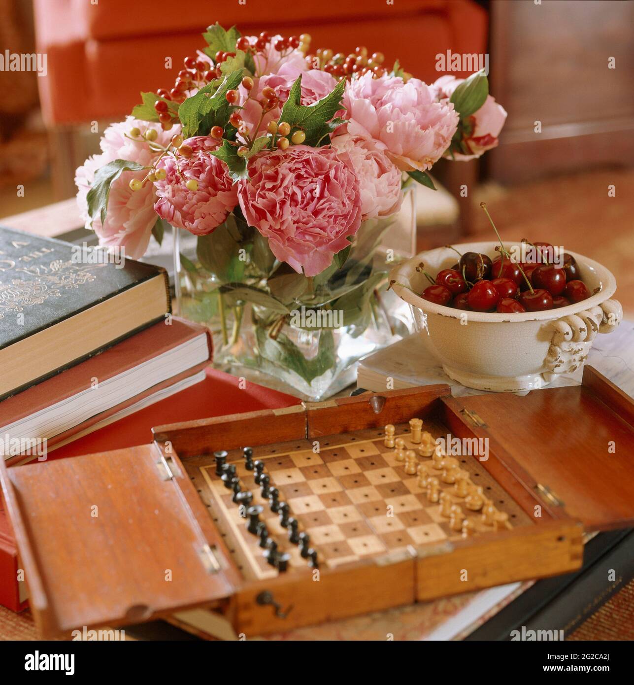 Flower and chess board on coffee table Stock Photo