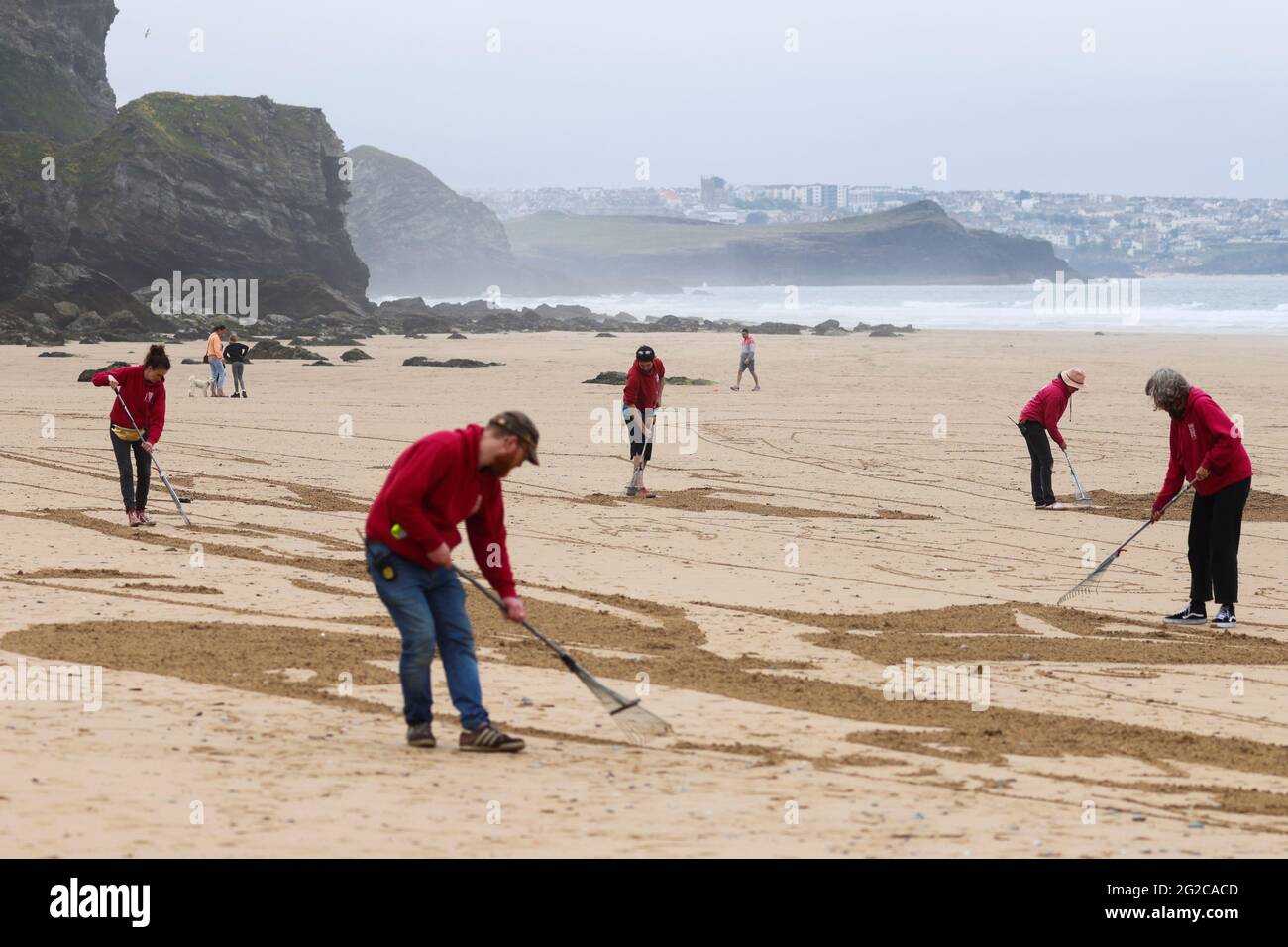 Campaign group Avaaz work to create a giant beach sand artwork depicting the faces of the G7 leaders alongside a message written in the sand reading 'Share the Vaccine, Waive the Patents', at Watergate Bay Beach, Newquay, Britain, June 10, 2021. REUTERS/Tom Nicholson Stock Photo