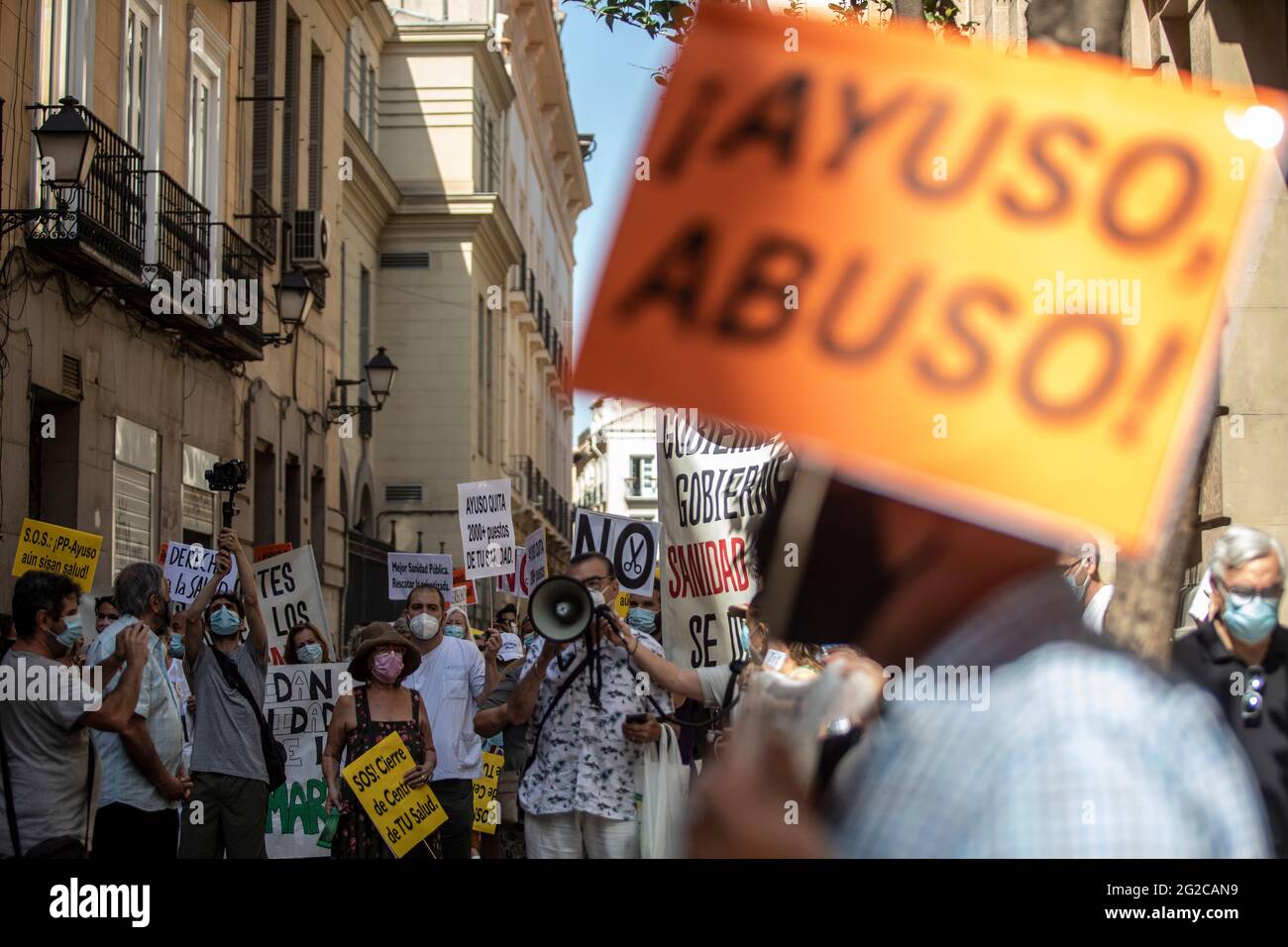 Madrid, Spain. 10th June, 2021. A protester reading out their demands on a megaphone, during the demonstration.A group of protesters gathered outside the Ministry of Health to demonstrate against the closures of health centres and primary care services. Credit: SOPA Images Limited/Alamy Live News Stock Photo