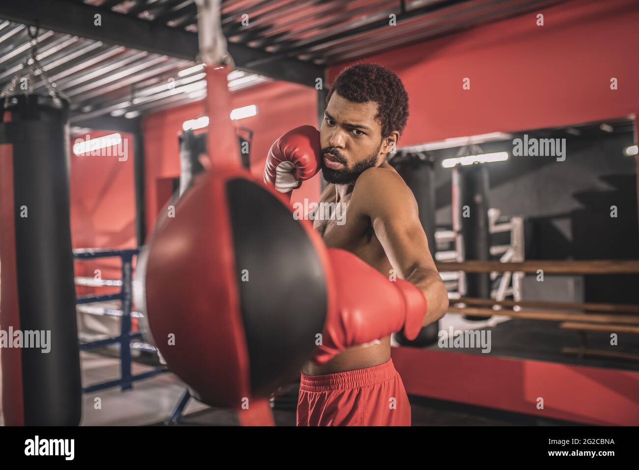 African american kickboxer having a workout in a gym and looking concentrated Stock Photo