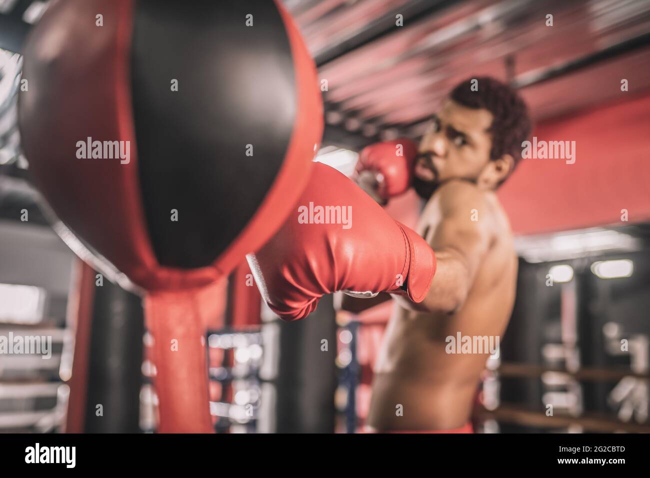 African american kickboxer having a workout in a gym and looking concentrated Stock Photo