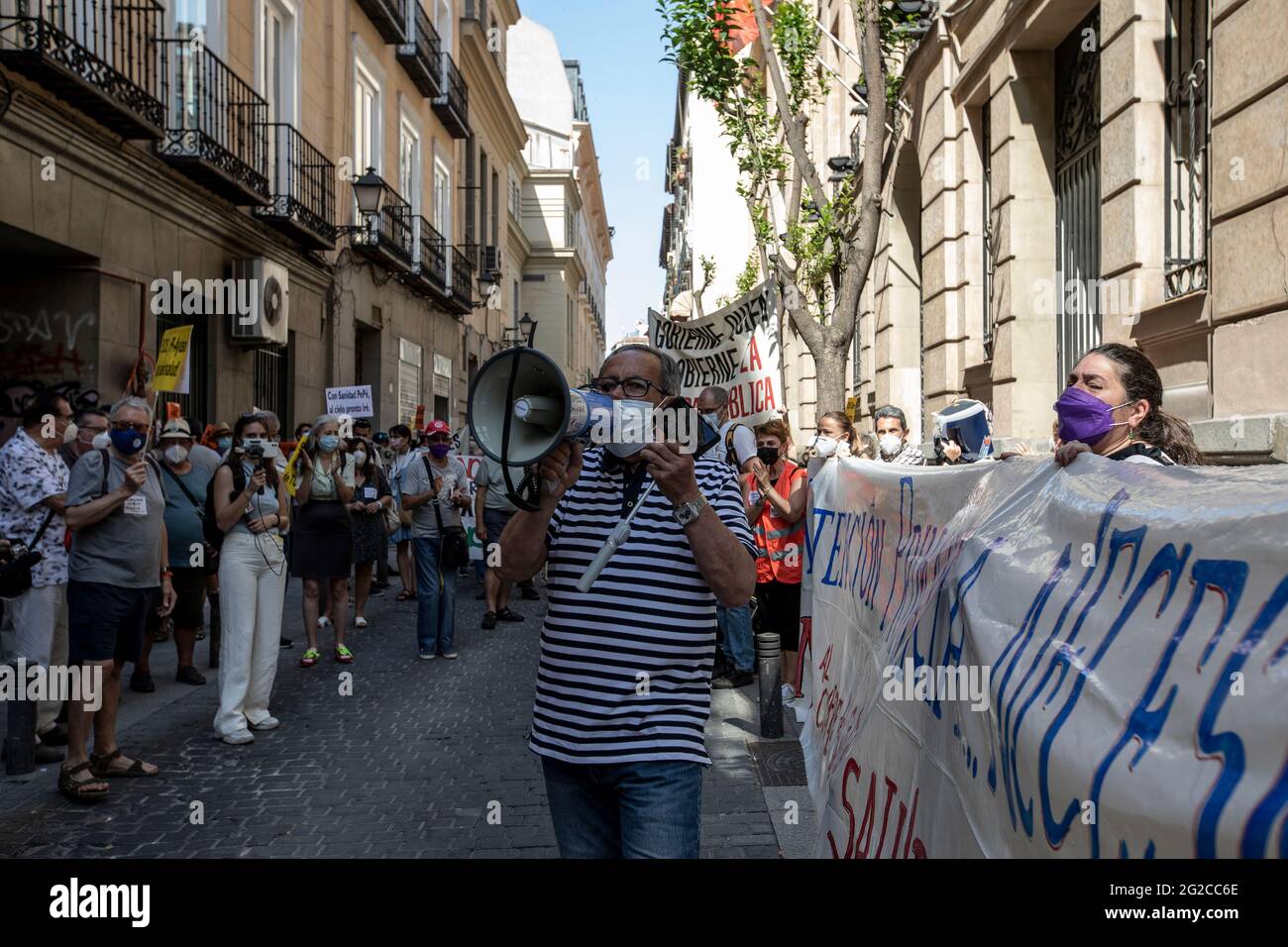 Madrid, Spain. 10th June, 2021. A protester speaking though a megaphone, during the demonstration.A group of protesters gathered outside the Ministry of Health to demonstrate against the closures of health centres and primary care services. Credit: SOPA Images Limited/Alamy Live News Stock Photo