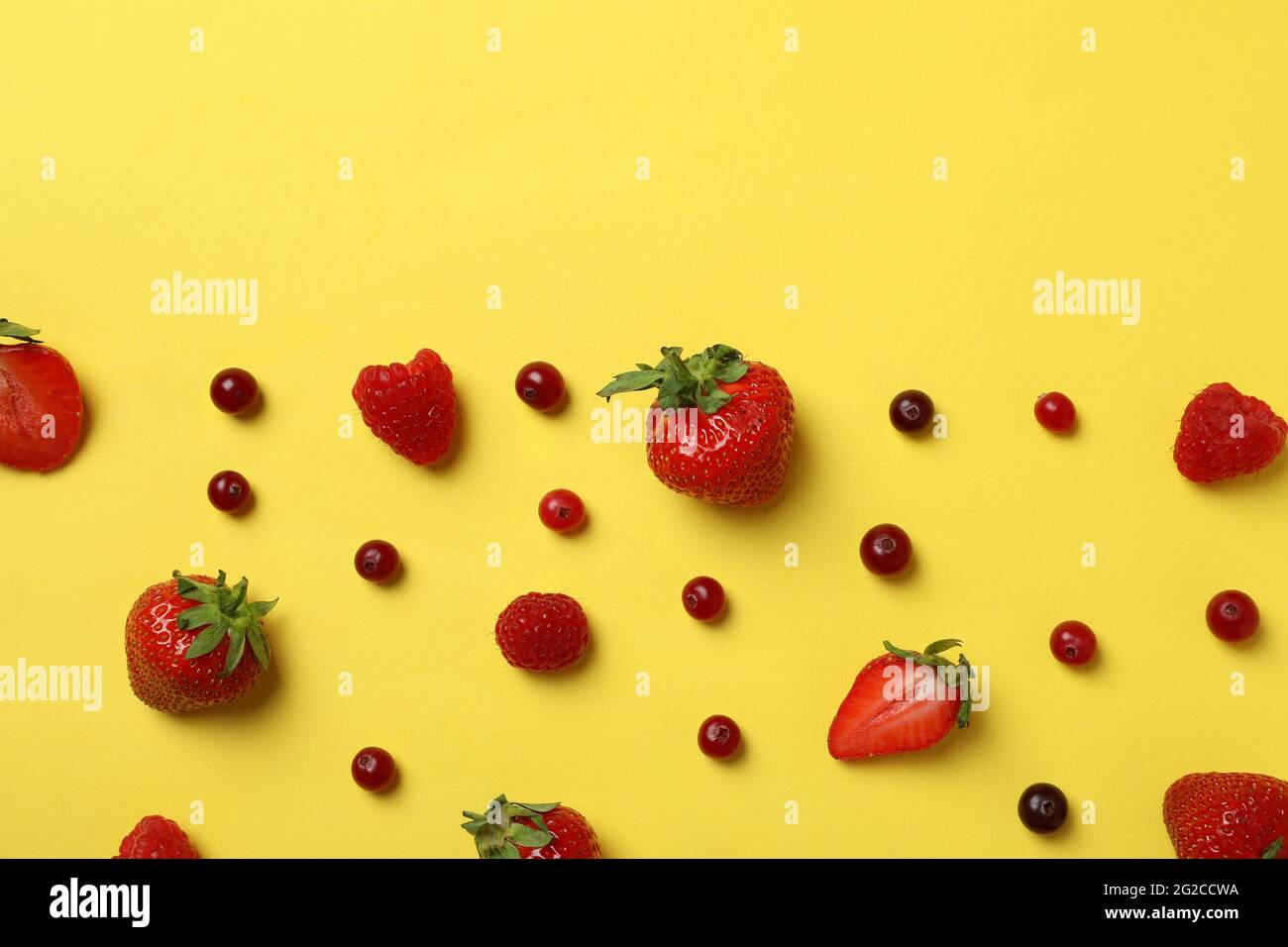 Delicious fresh berry mix on yellow background Stock Photo - Alamy