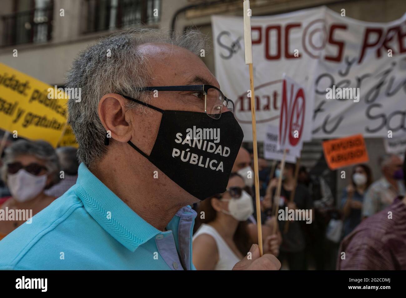 A protester wearing a facemask saying Public Health during the demonstration.A group of protesters gathered outside the Ministry of Health to demonstrate against the closures of health centres and primary care services. (Photo by Guillermo Gutierrez Carrascal / SOPA Images/Sipa USA) Stock Photo