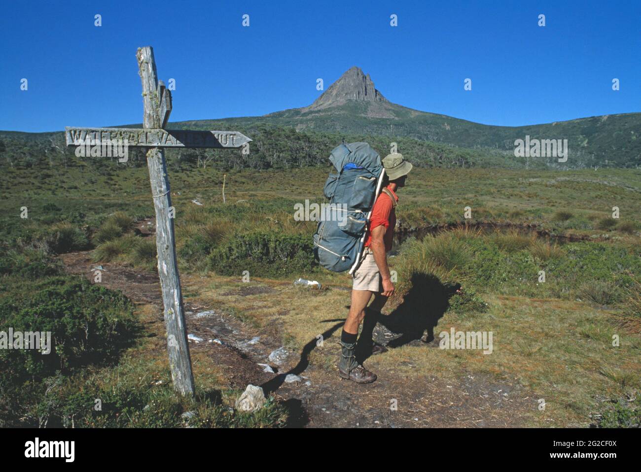 Australia. Tasmania. Central Highlands region. Bushwalker on track with view of Barn Bluff. Stock Photo
