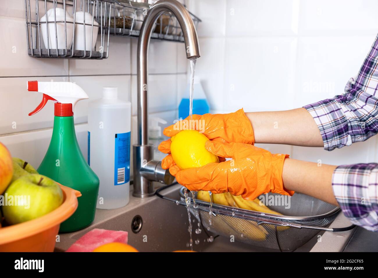 Fresh fruits washing with water flowing in kitchen sink Stock Photo Alamy
