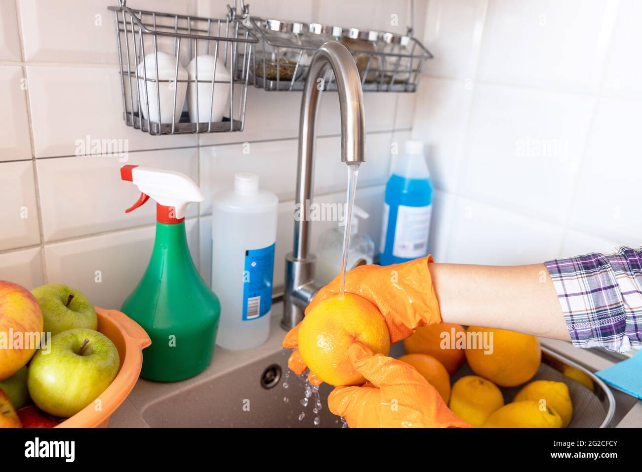 Fresh fruits washing with water flowing in kitchen sink Stock Photo Alamy