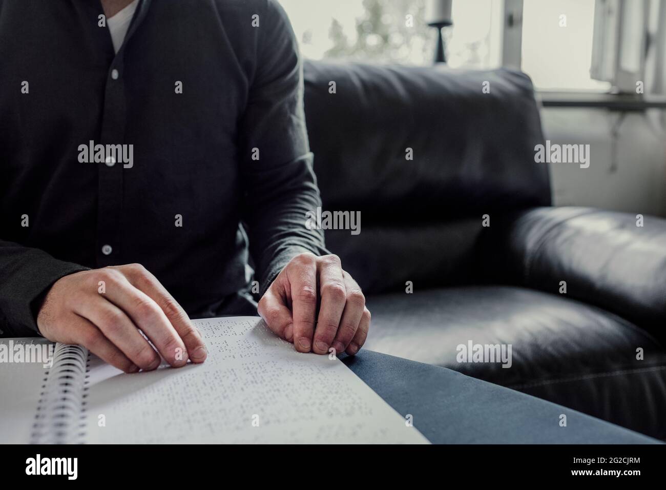 Man reading Braille book Stock Photo