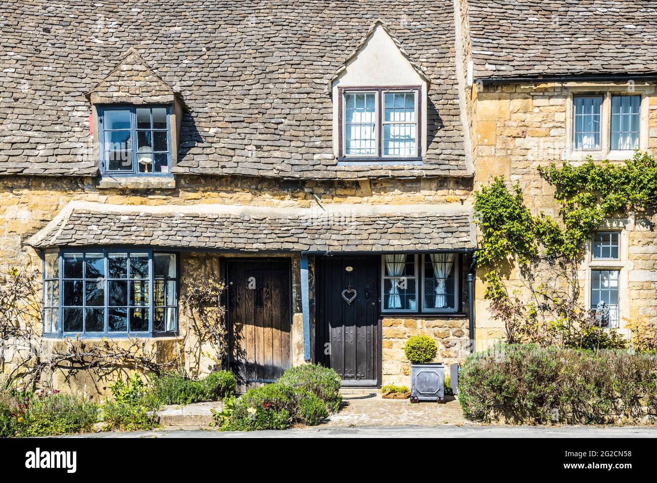 A couple of pretty stone cottages in the Cotswold town of Broadway in Worcestershire. Stock Photo