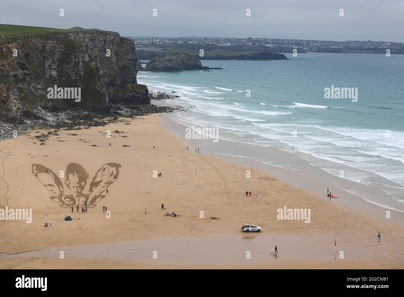 A general view of a giant beach sand artwork depicting the faces of the G7 leaders alongside a message written in the sand reading 'Share the Vaccine, Waive the Patents', at Watergate Bay Beach, Newquay, Britain, June 10, 2021. REUTERS/Tom Nicholson Stock Photo